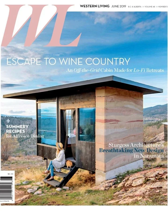 Magazine cover of Western Living, June 2019 issue, featuring a small modern off-the-grid cabin with a panoramic view of the mountains and sky, with a woman sitting on the steps outside.