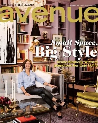 Magazine cover featuring a woman sitting on a gray sofa in a stylish living room with pink shelves and various decor items, titled 'Avenue' with headlines about small space, big style, and Kimberly Wiebe's heritage home.