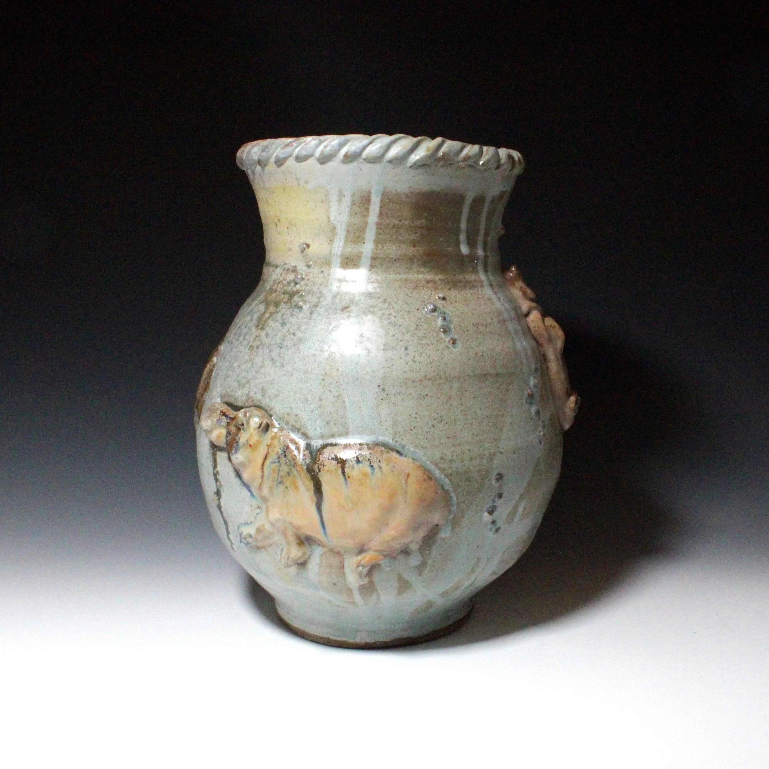 Small textured dots in sets on the side of the pot add feeling and depth to the happy water scene. Drips of blue over brown mimic light as it shines through water in beams. 