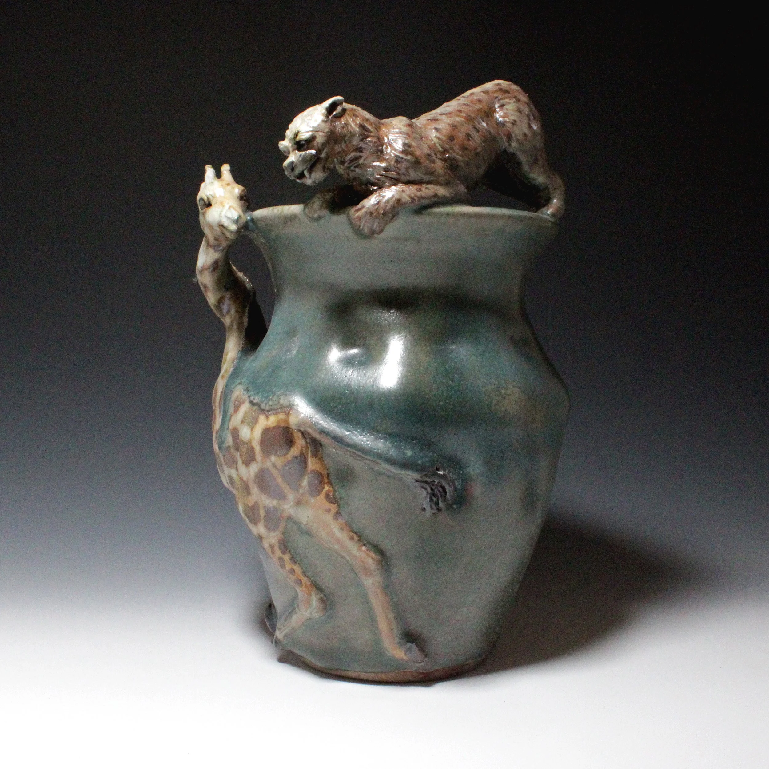 The cheetah has gained the advantage by perching on the rim of the lumpy green vase over top of the tall giraffe. 