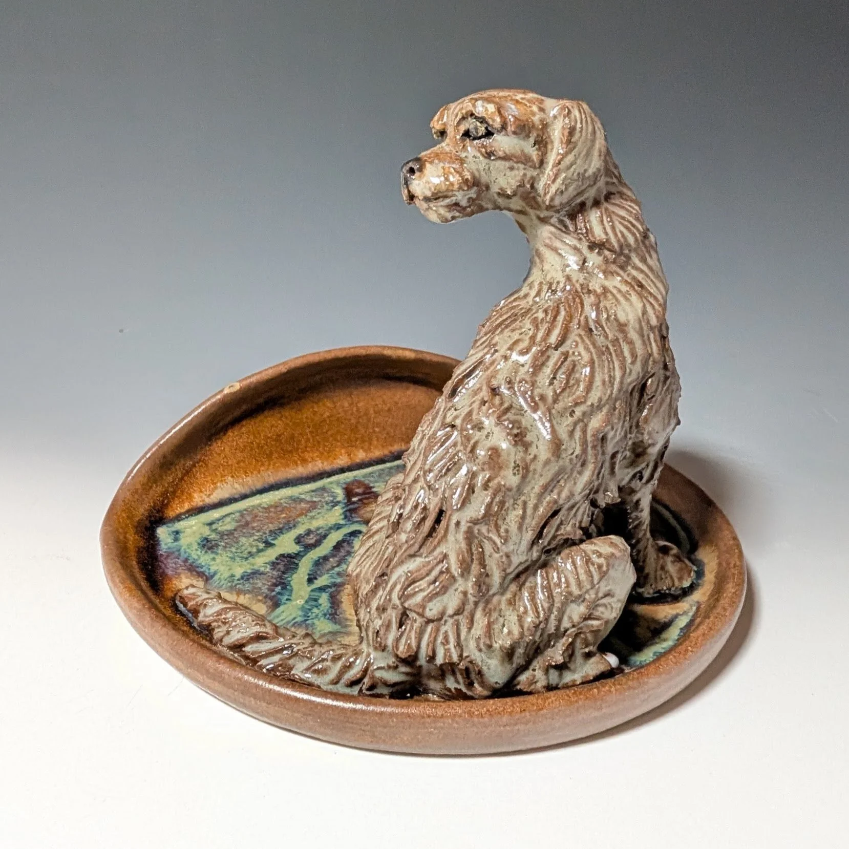 Irish wolfhound dog figurine sitting on a sponge drying plate