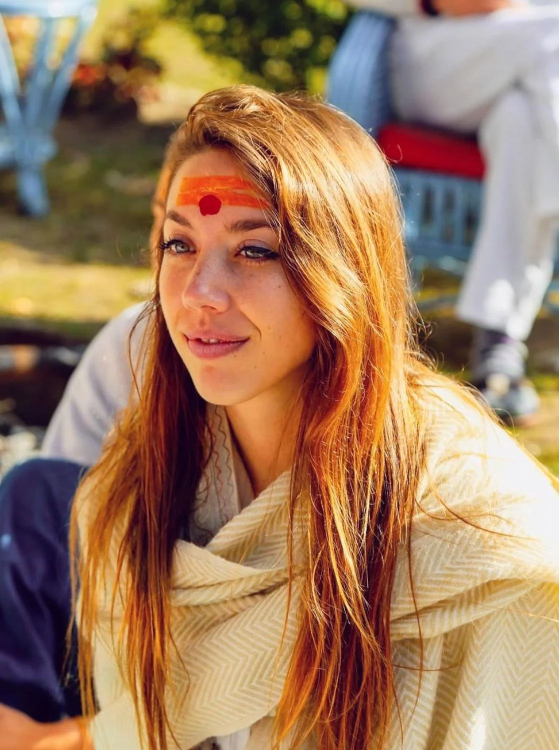 Girl with tillicum on forehead at traditional Indian ceremony wearing scarves
