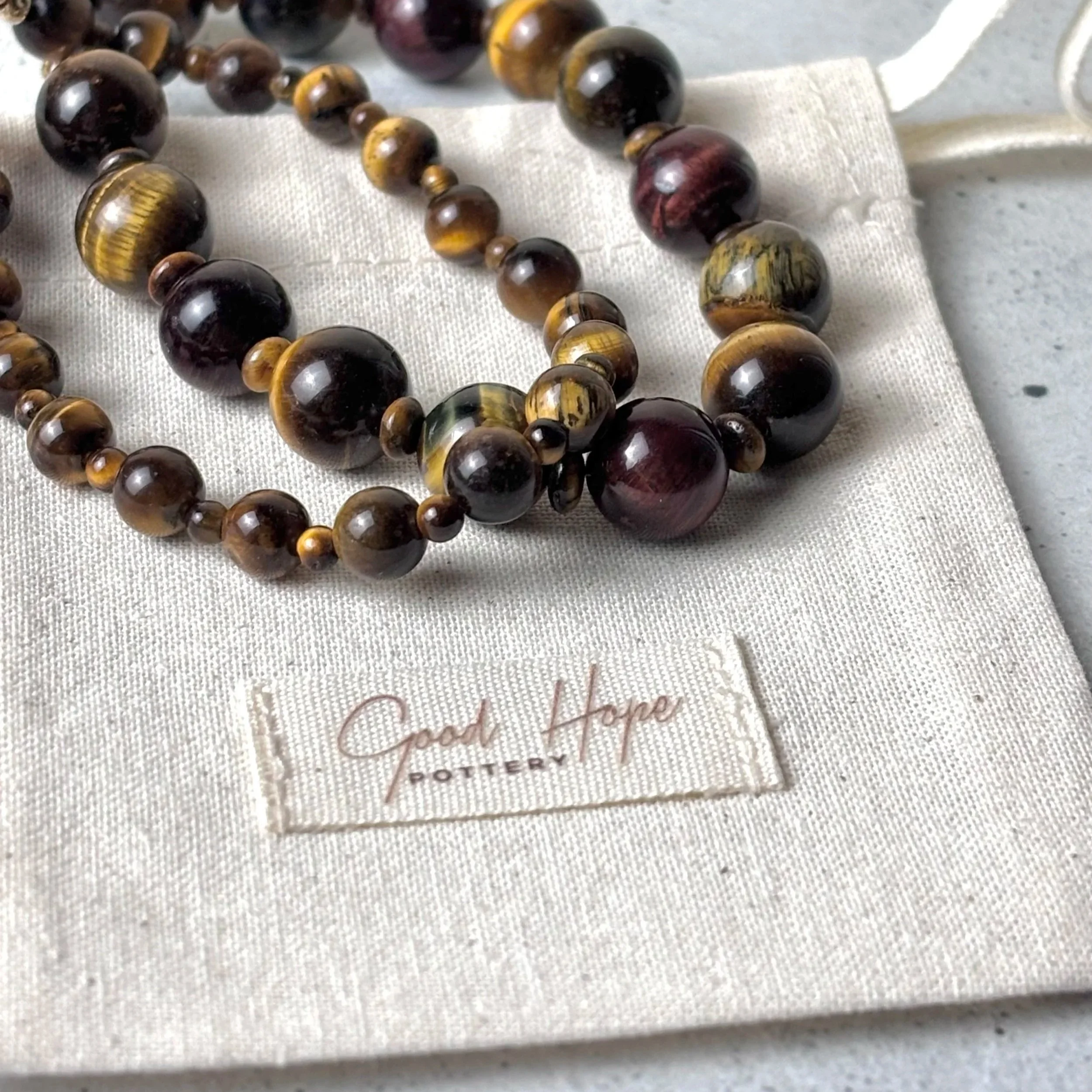 Handmade Grounded bracelet with tiger eye stones on a linen gift bag