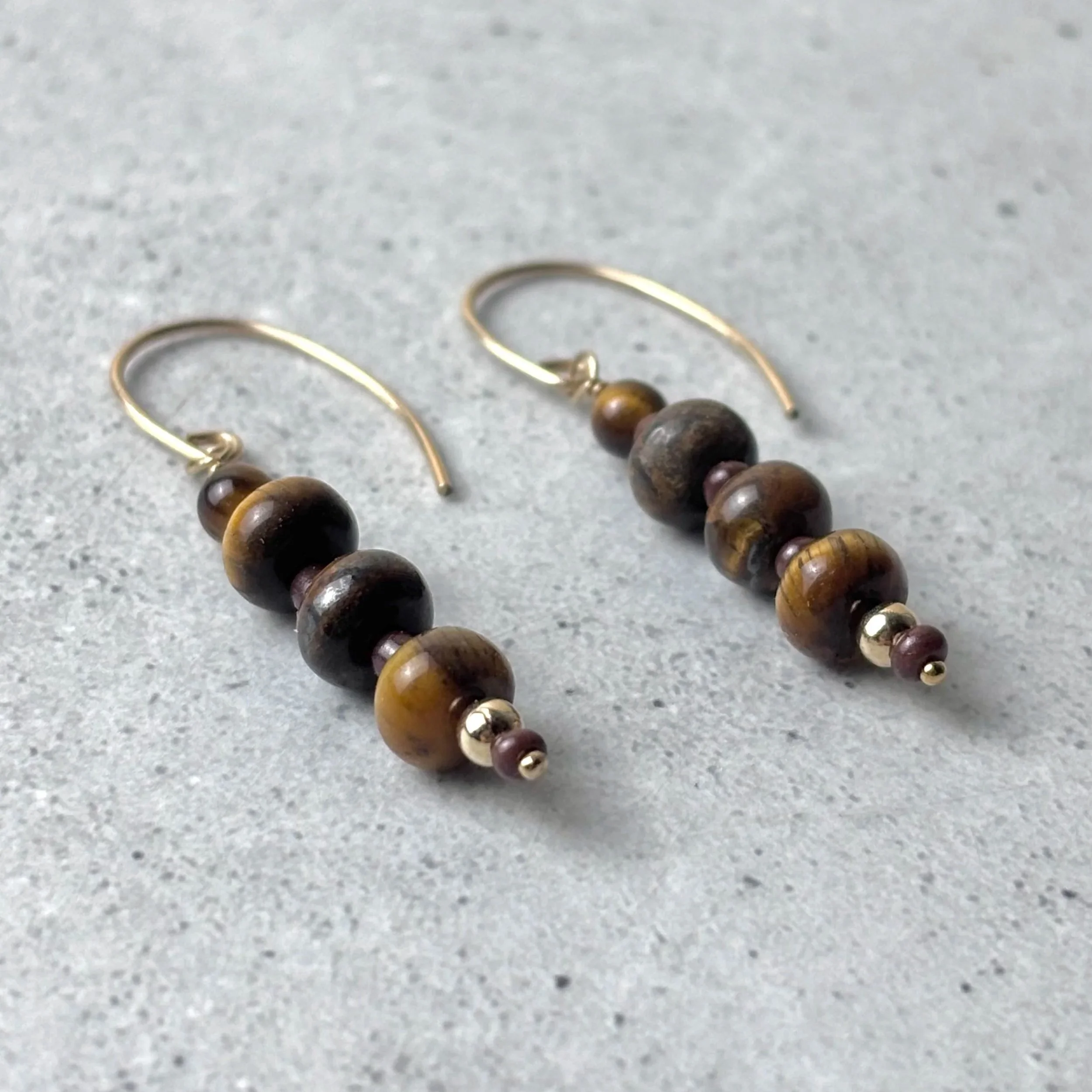Gathered earrings featuring groups of tiger eye stones on a shepherd hook earring