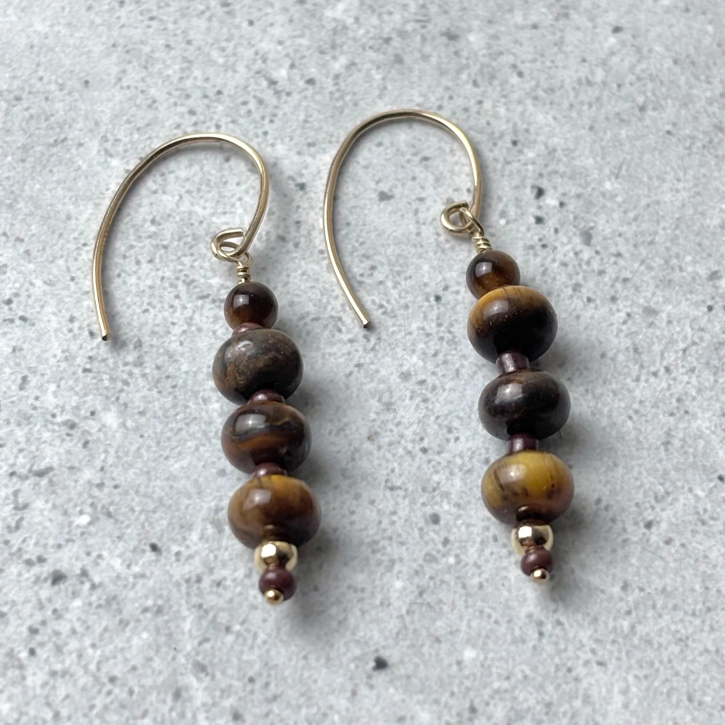 Gathered earrings featuring groups of tiger eye stones on a shepherd hook earring