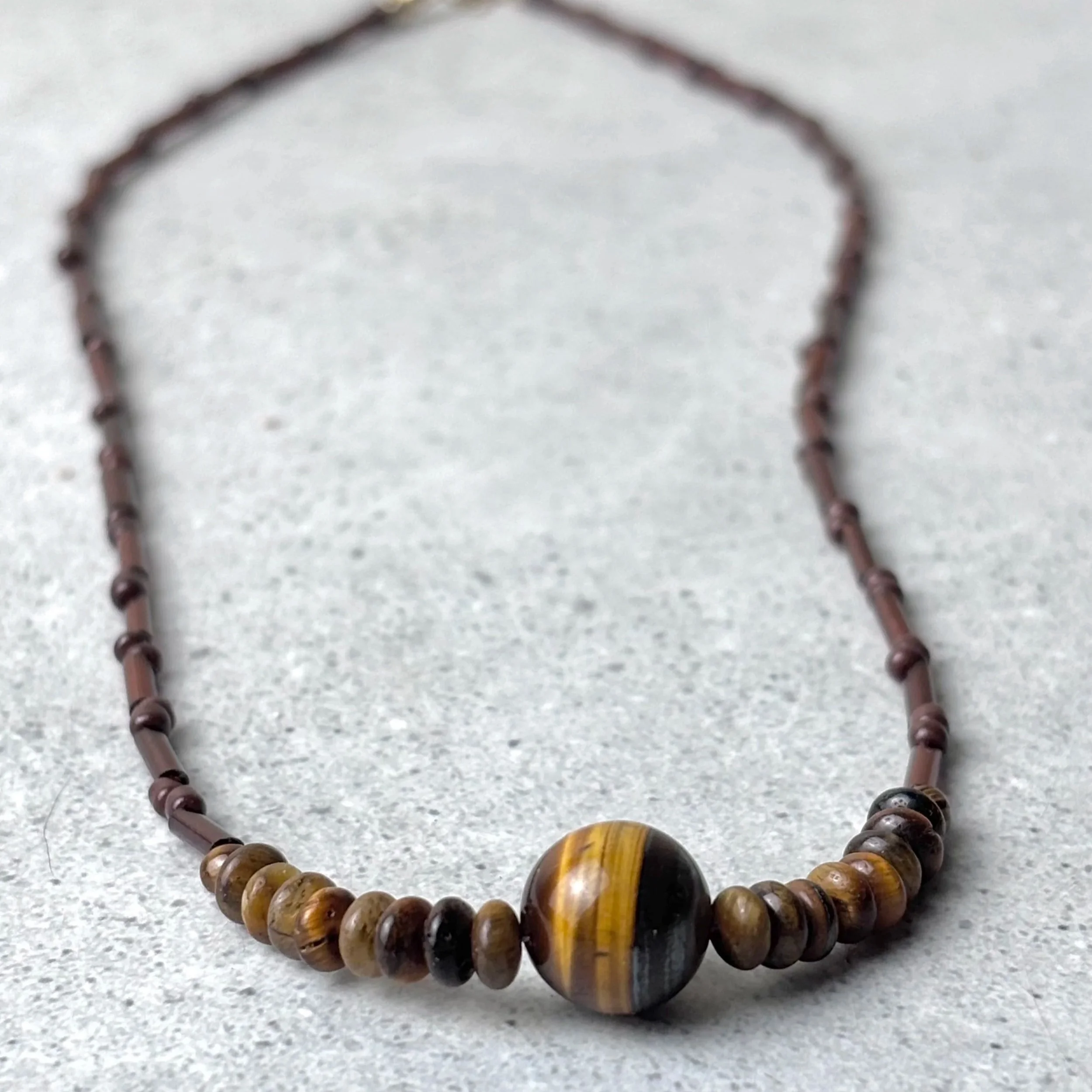 anchored necklace featuring tiger eye stone