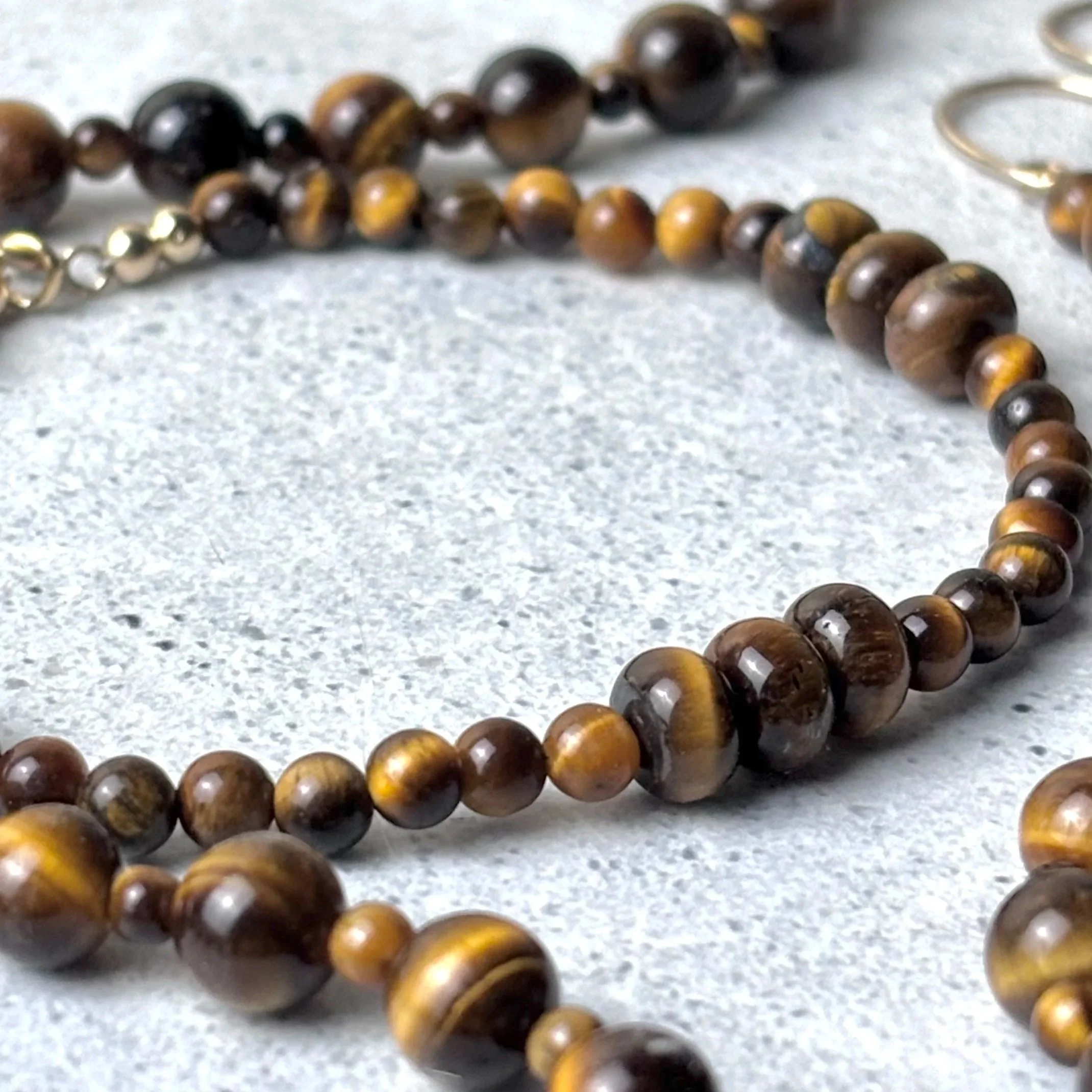 Gathered bracelet featuring groups of tiger eye stones on a fine strand