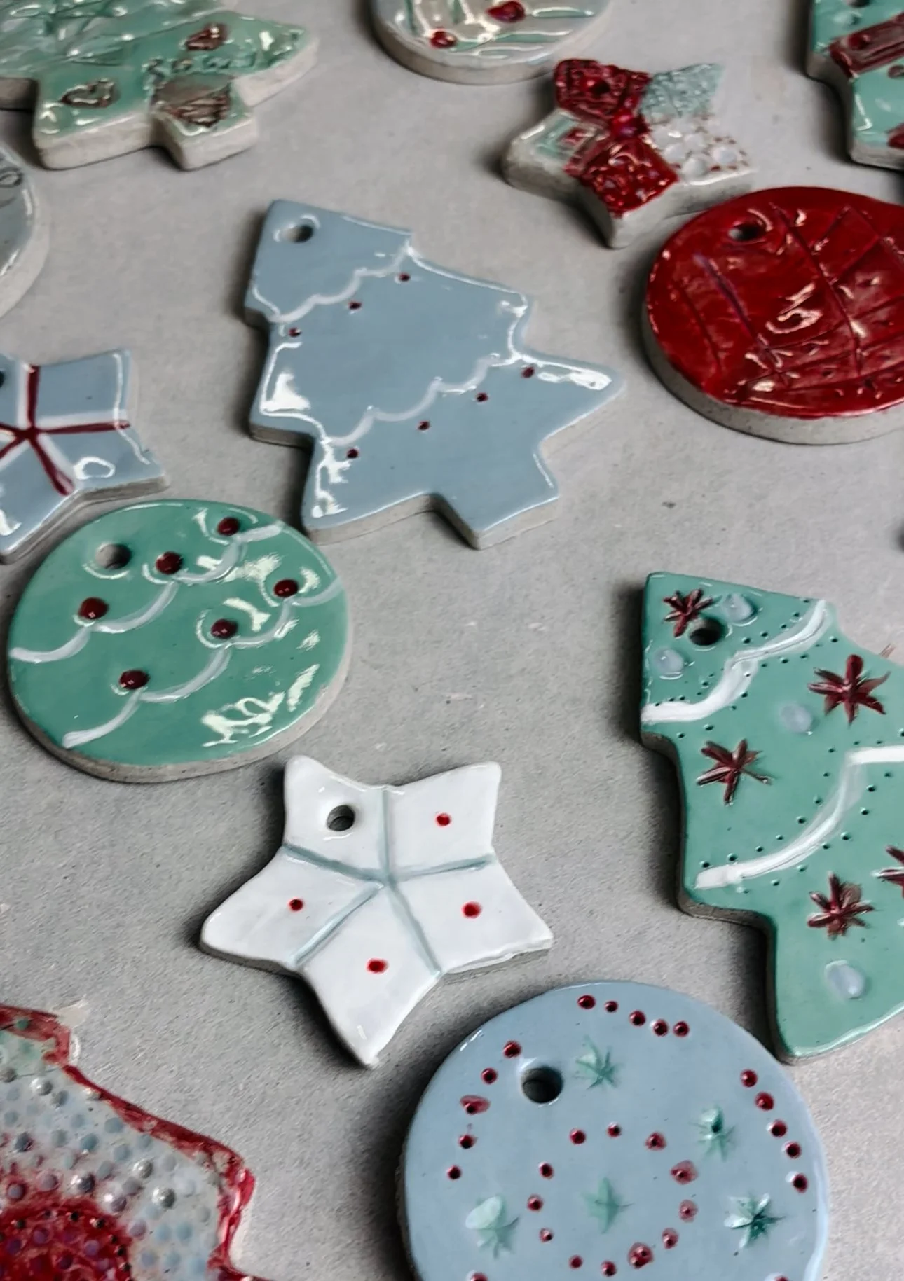 Students painting and shaping pottery Christmas decorations during a class