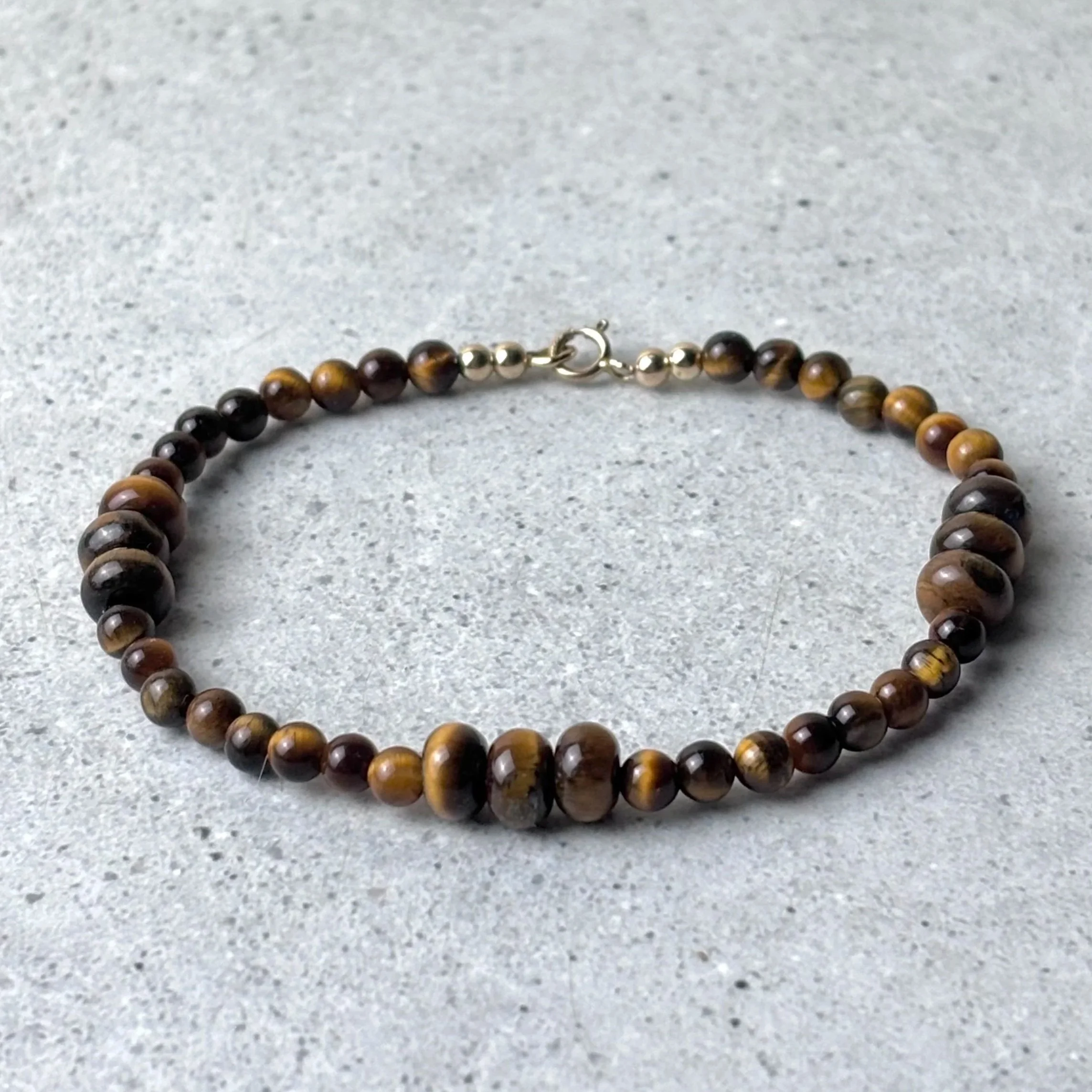 Gathered bracelet featuring groups of tiger eye stones on a fine strand