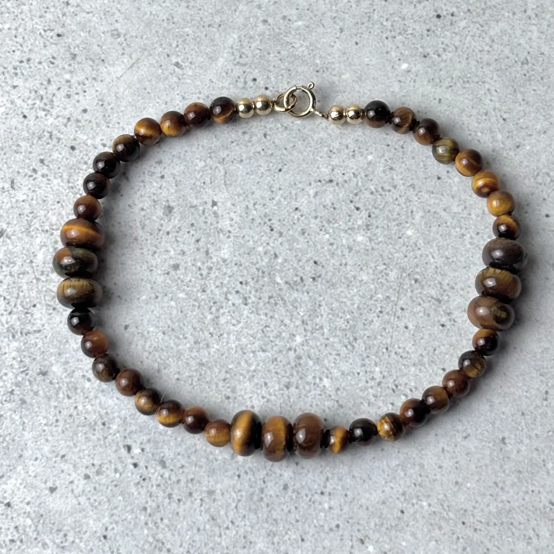 Gathered bracelet featuring groups of tiger eye stones on a fine strand