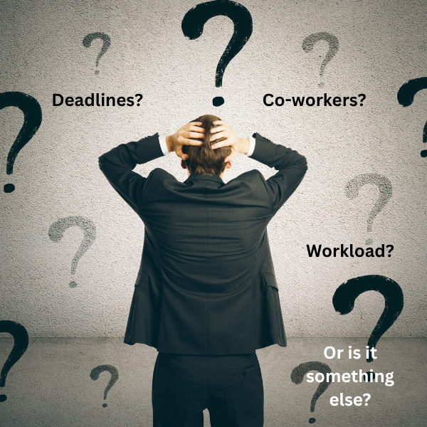 A businessman looking toward a board of question makrs