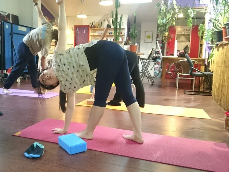 Moment de sérénité lors d’un cours de yoga en entreprise à Carcassonne, Aude, Occitanie favorisant détente et productivité au travail.