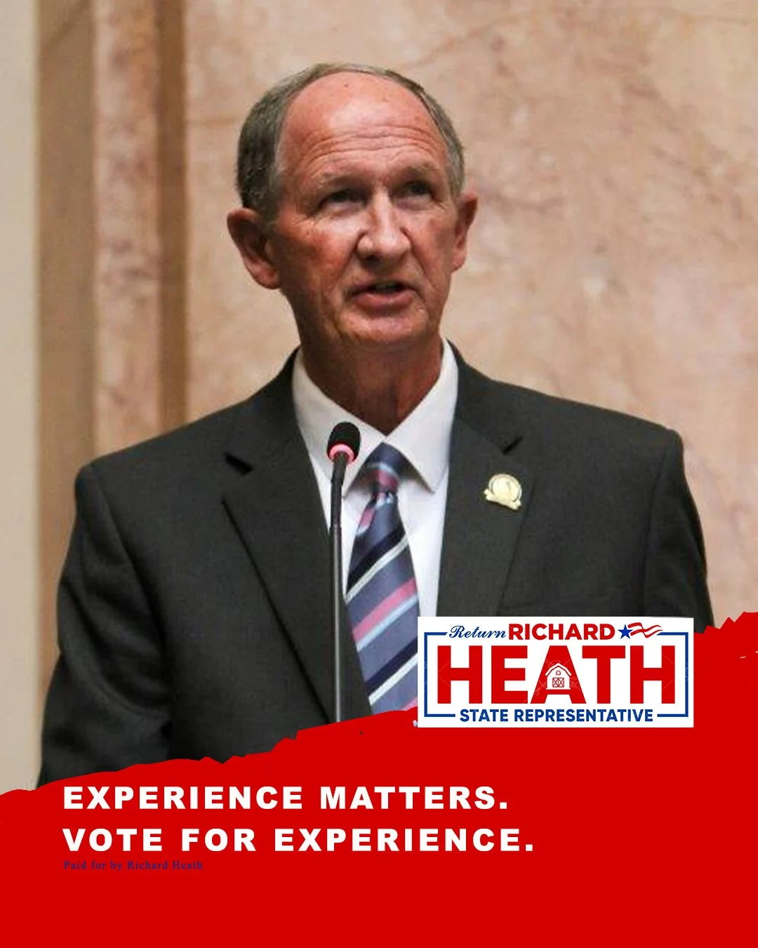 Portrait of a man in a suit and tie speaking at a podium, with a campaign sign that reads "Return Richard Heath, State Representative" and a slogan "Experience Matters. Vote for Experience."