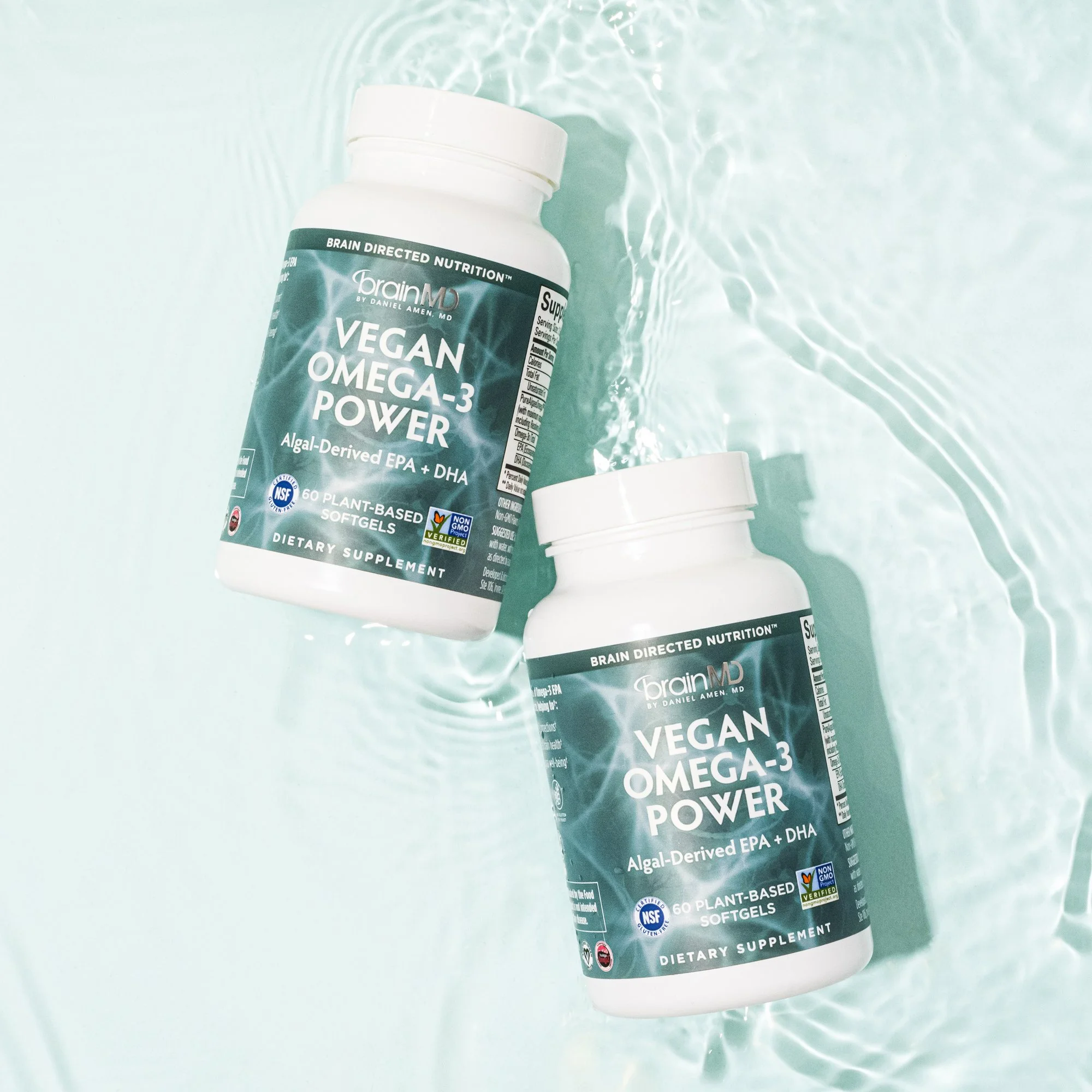 Two bottles of vegan Omega-3 Power dietary supplements floating in water.