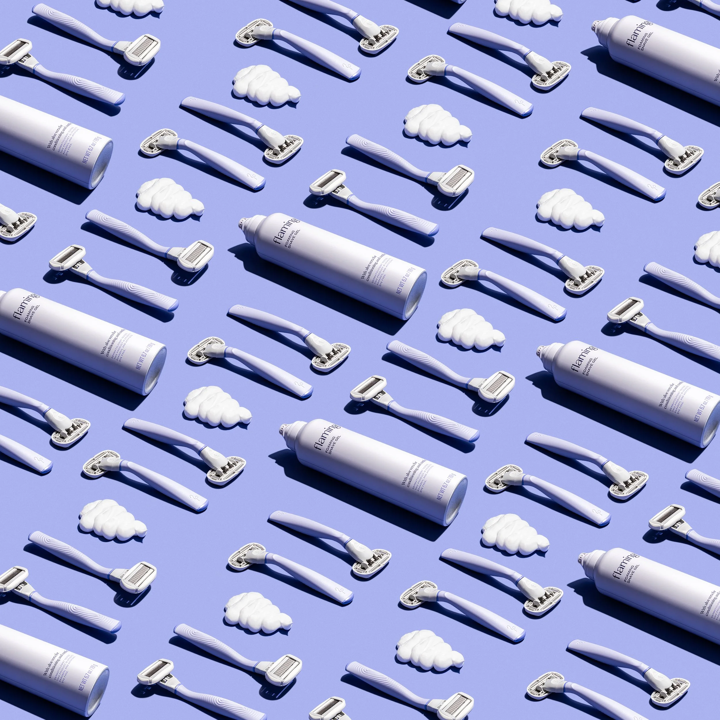 Pattern of white razors, shaving foam clouds, and bottles of shaving foam on a purple background.