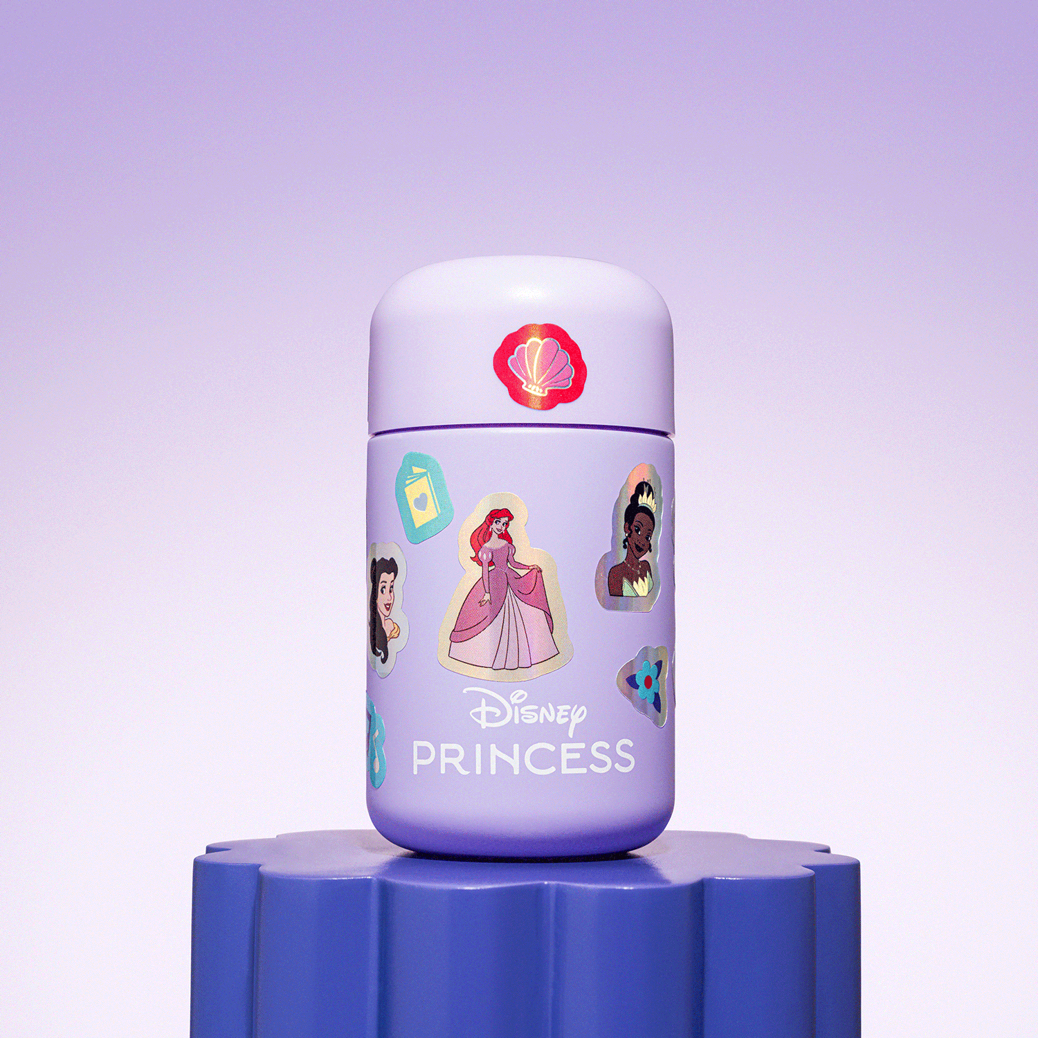 A Disney Princess-themed bottle resting on a blue pedestal, decorated with stickers of Disney princesses, a butterfly, and a seashell symbol on top.
