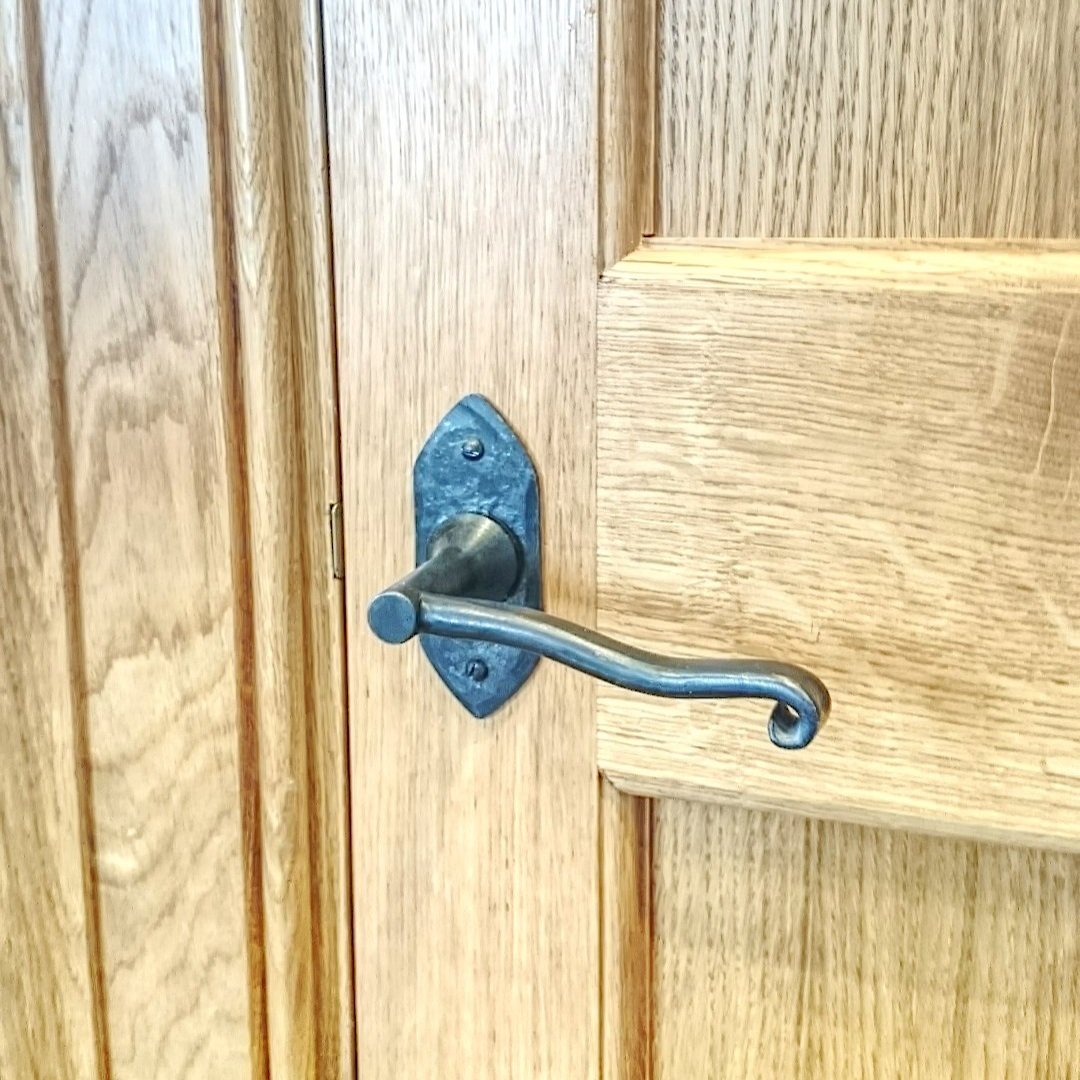 AD Designs hand forged and fabricated bespoke door handle on oak door