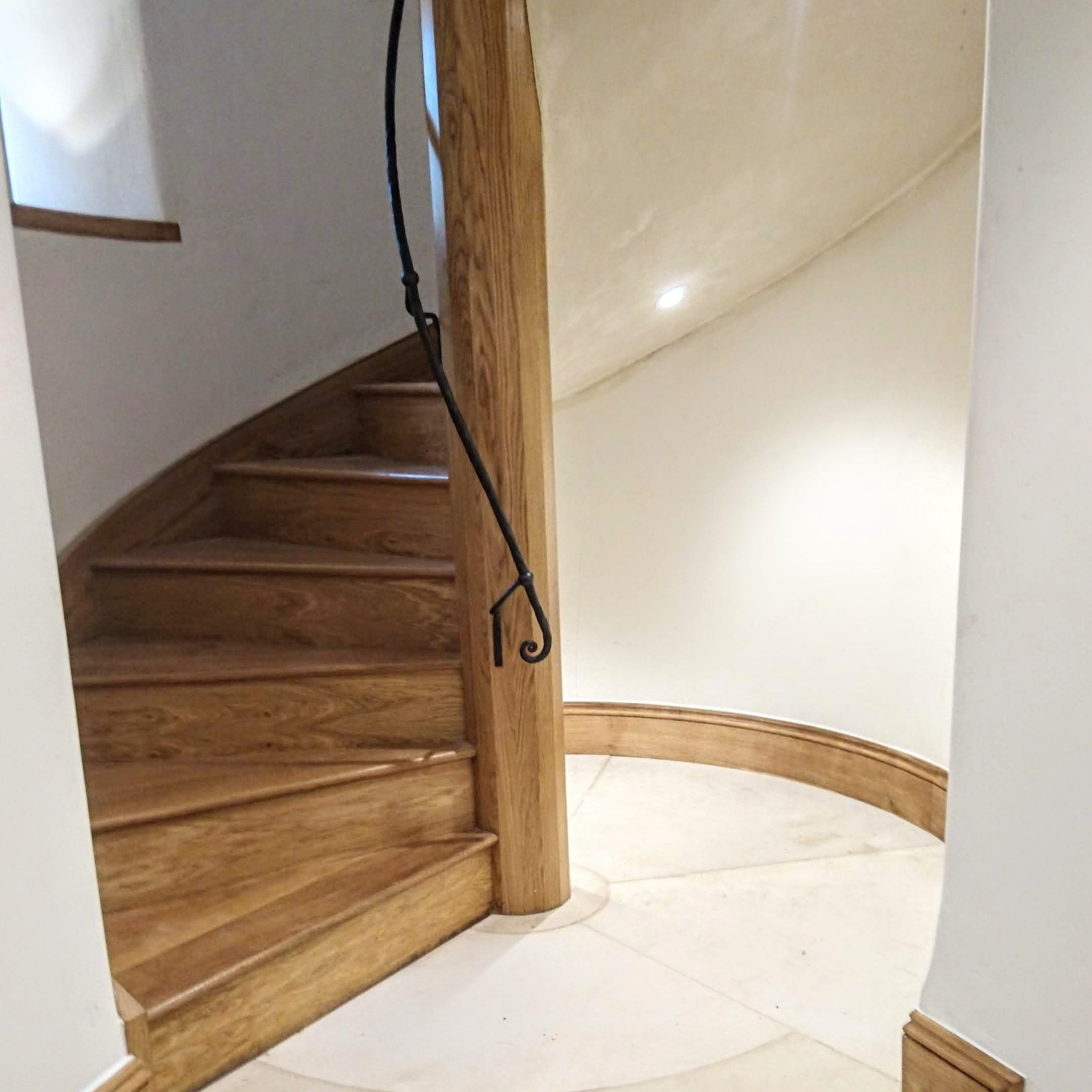 AD Designs hand forged bespoke spiral staircase handrail on oak staircase