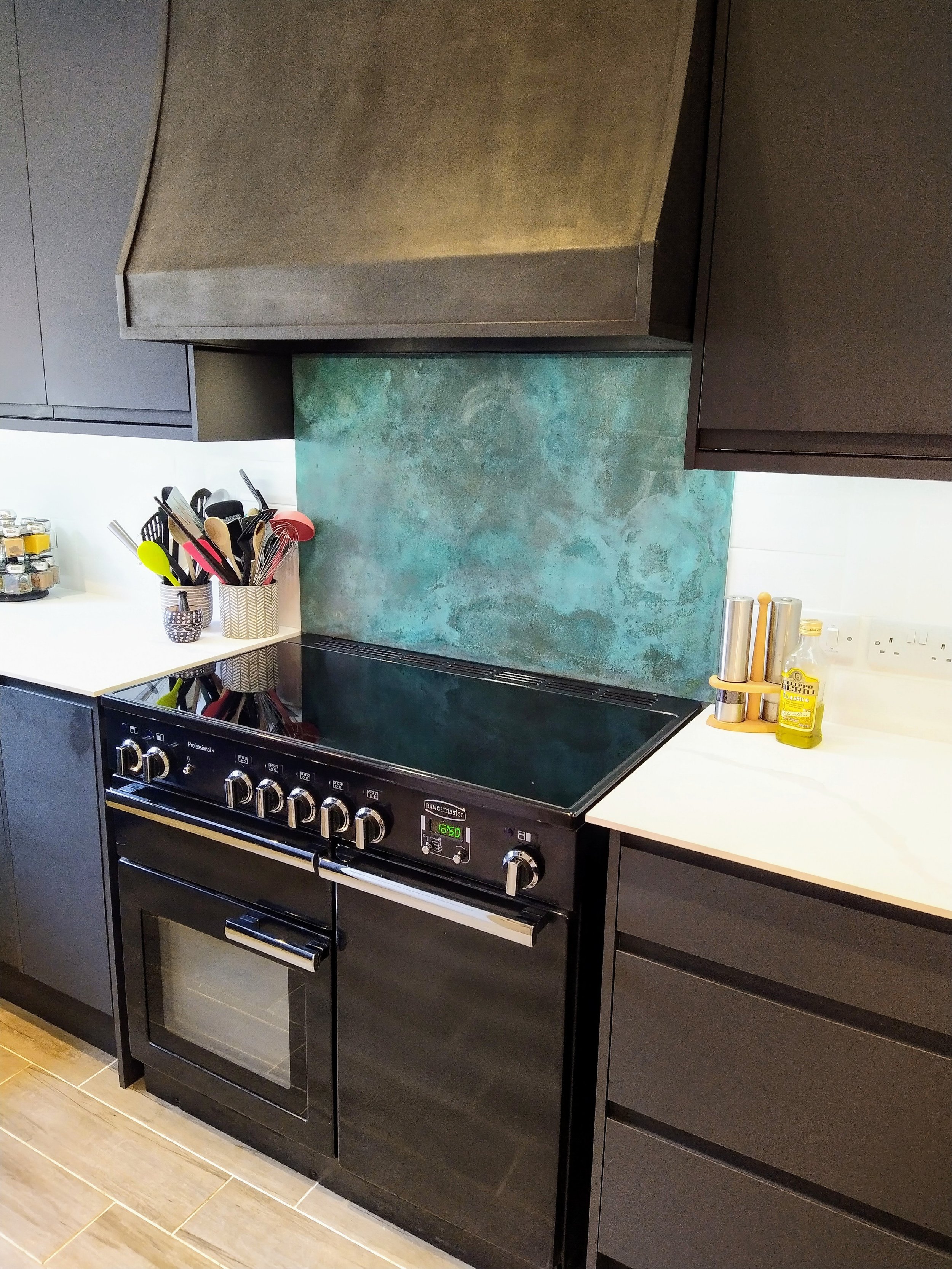 AD Designs bespoke patinated verdigris splashback and graphite steel cooker hood