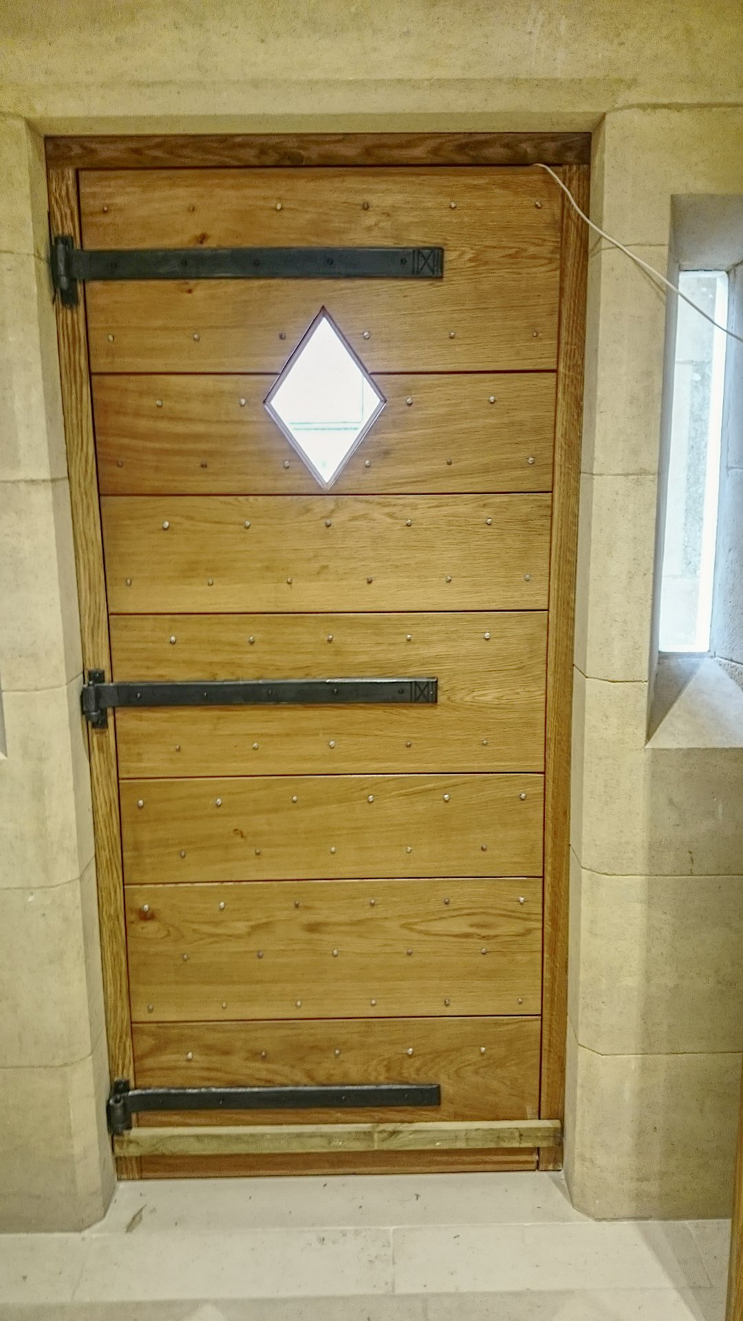 AD Designs hand forged bespoke steel hinge on oak door.