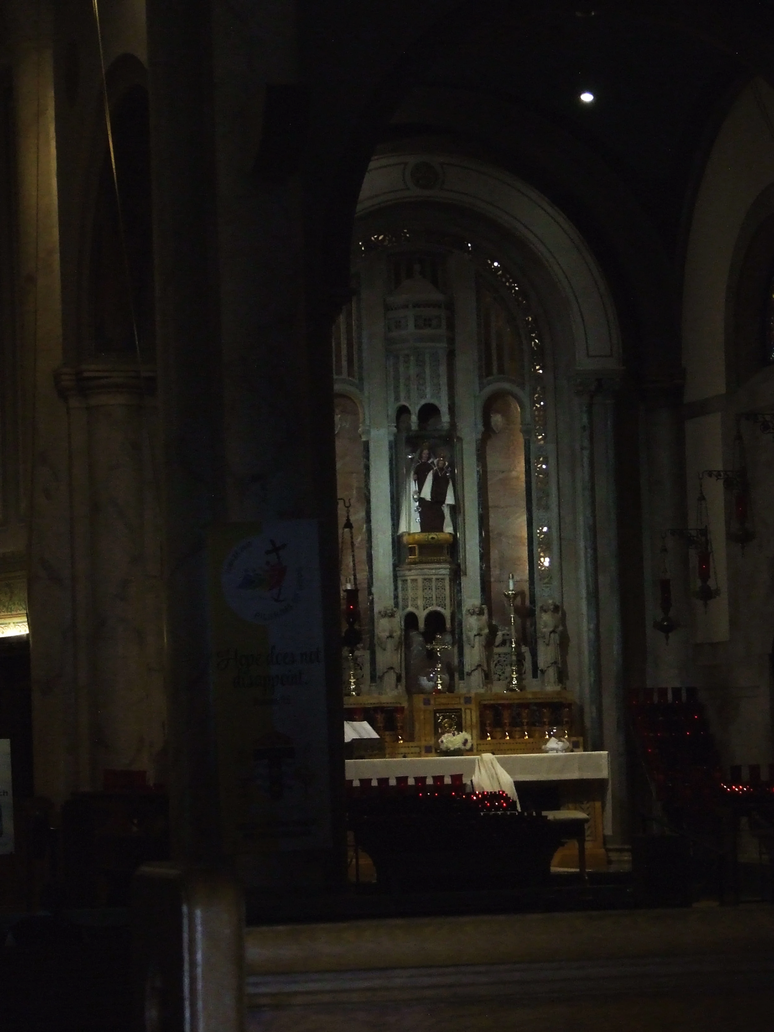 A Sister prays before Our Lady of Consolation