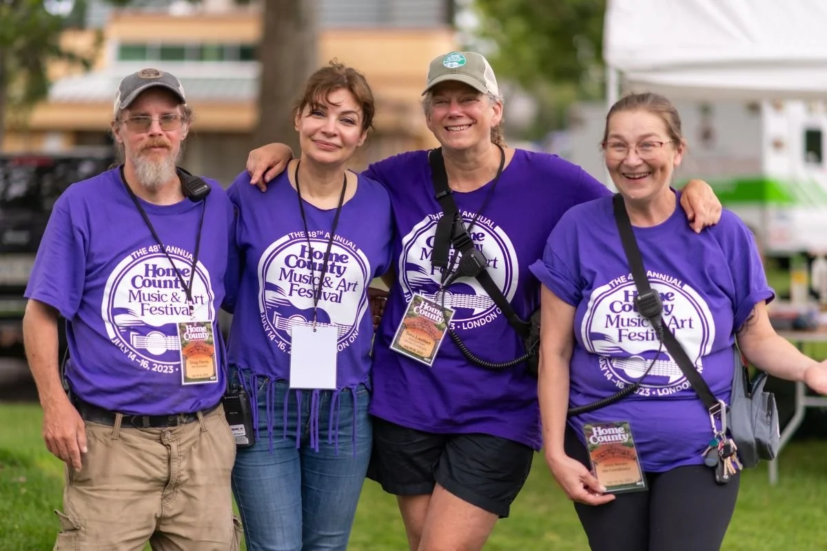Group of 4 people working at Home County Music & Art Festival