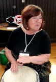 Sheila Horrell leading a community drumming performance at Home County Music & Art Festival in London, Ontario