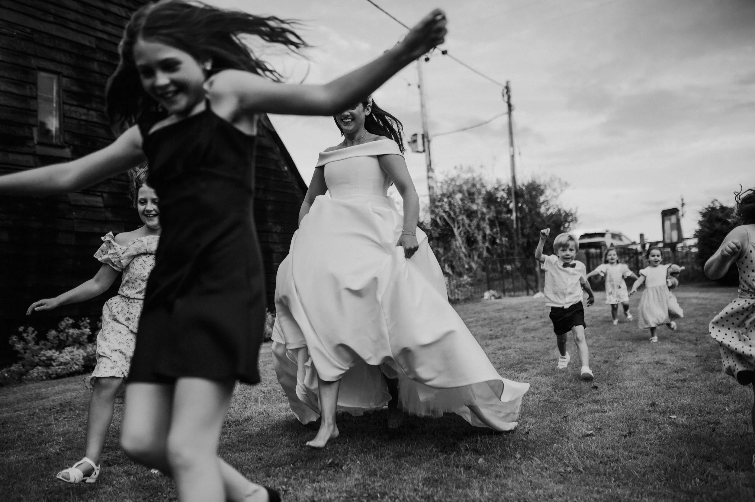 bride running with children at her wedding