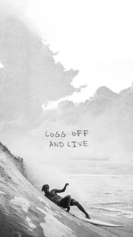 A person surfing on a wave with a cloudy sky in the background and the words "Look off and live" written in the sky.