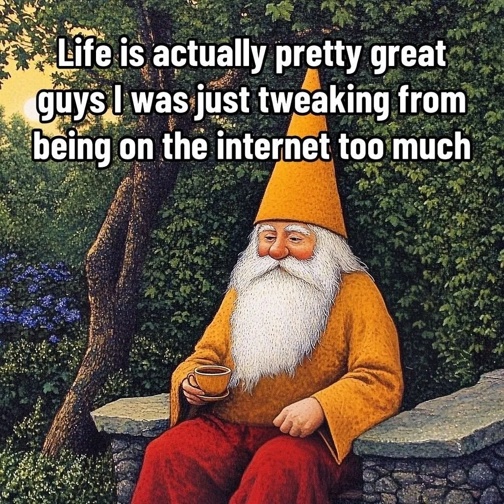 A garden gnome with a long white beard, orange hat, and orange shirt sitting outside on a stone ledge, holding a small cup, with trees and bushes in the background.