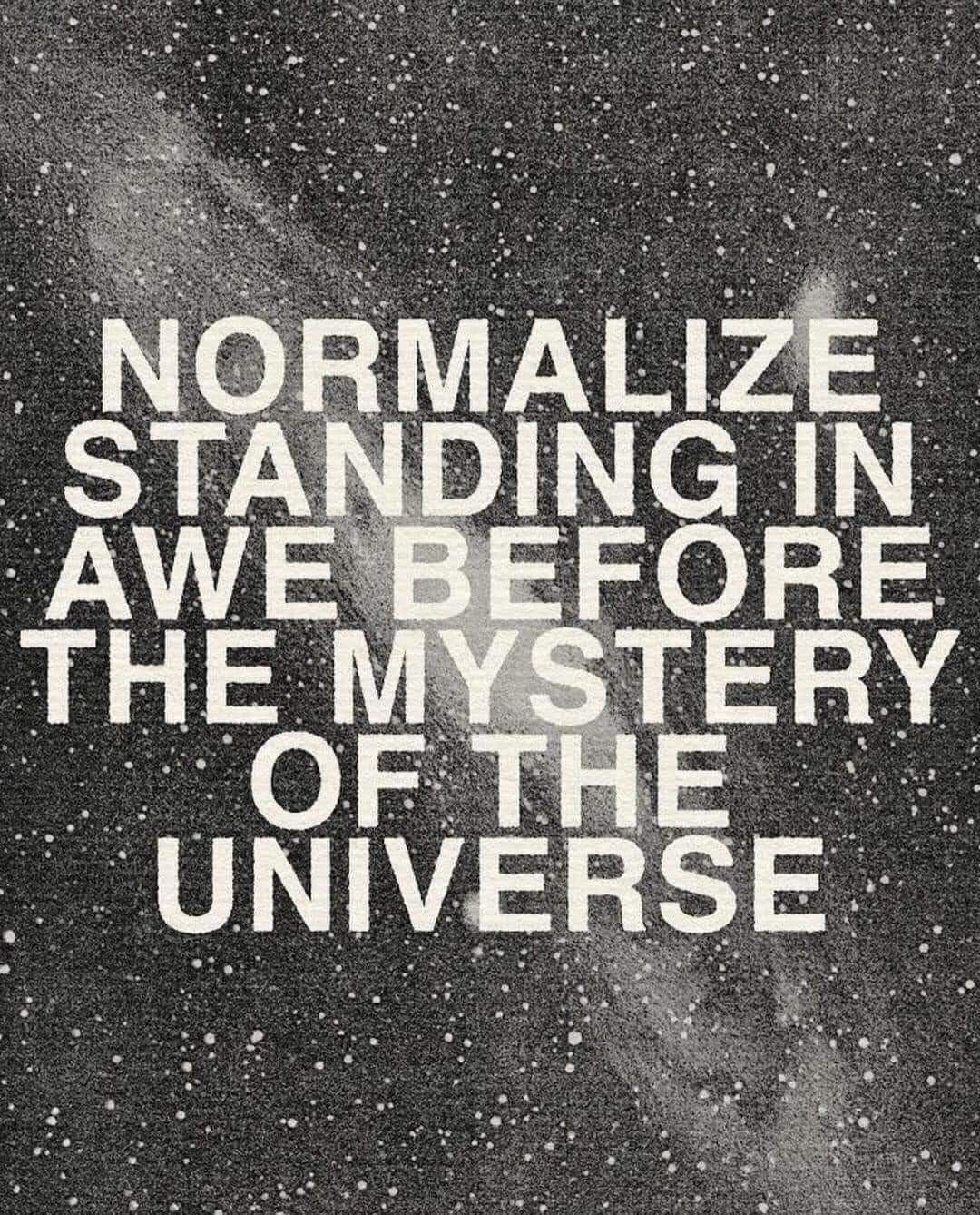 Quote in white text on a starry black and gray background that reads, "Normalize standing in awe before the mystery of the universe."