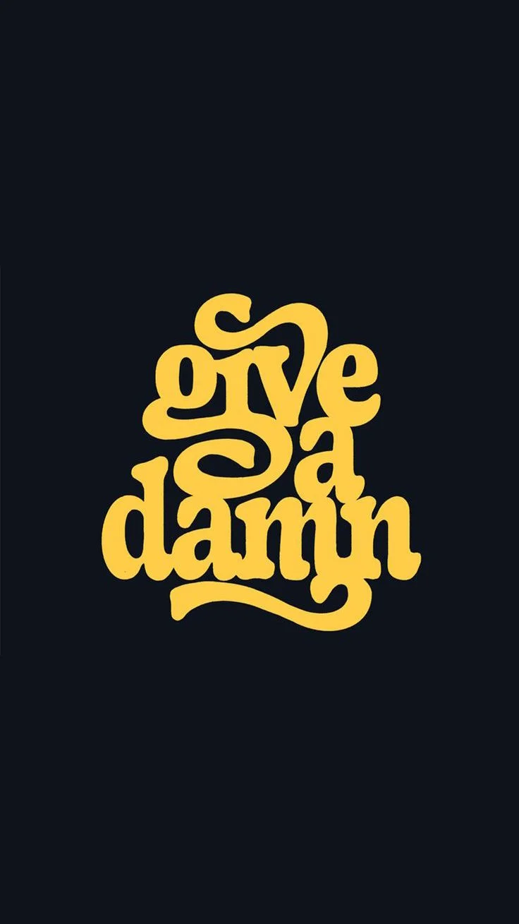 Typography design with the phrase "give a damn" in yellow, stylized, handwritten font on a black background.
