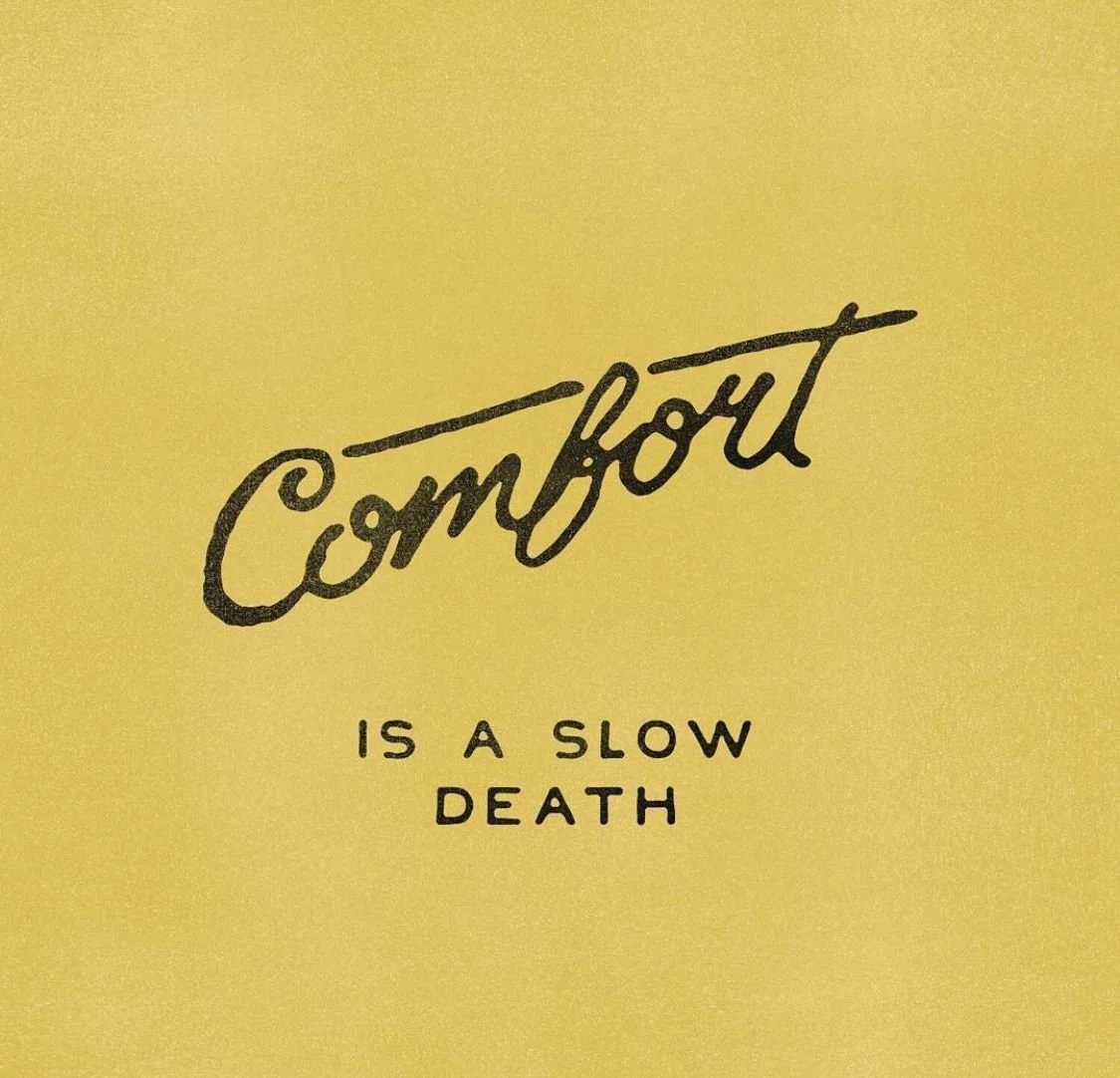 The image has yellow background with black text reading 'Comfort is a slow death'.