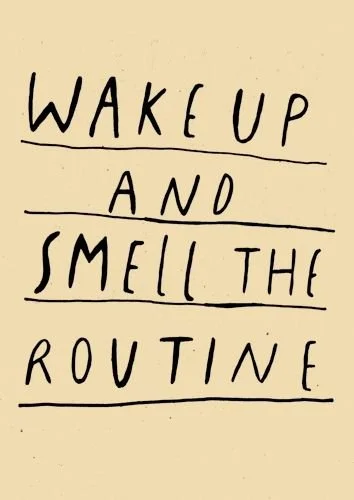 Handwritten note with the message 'Wake Up and Smell the Routine' on a beige background.