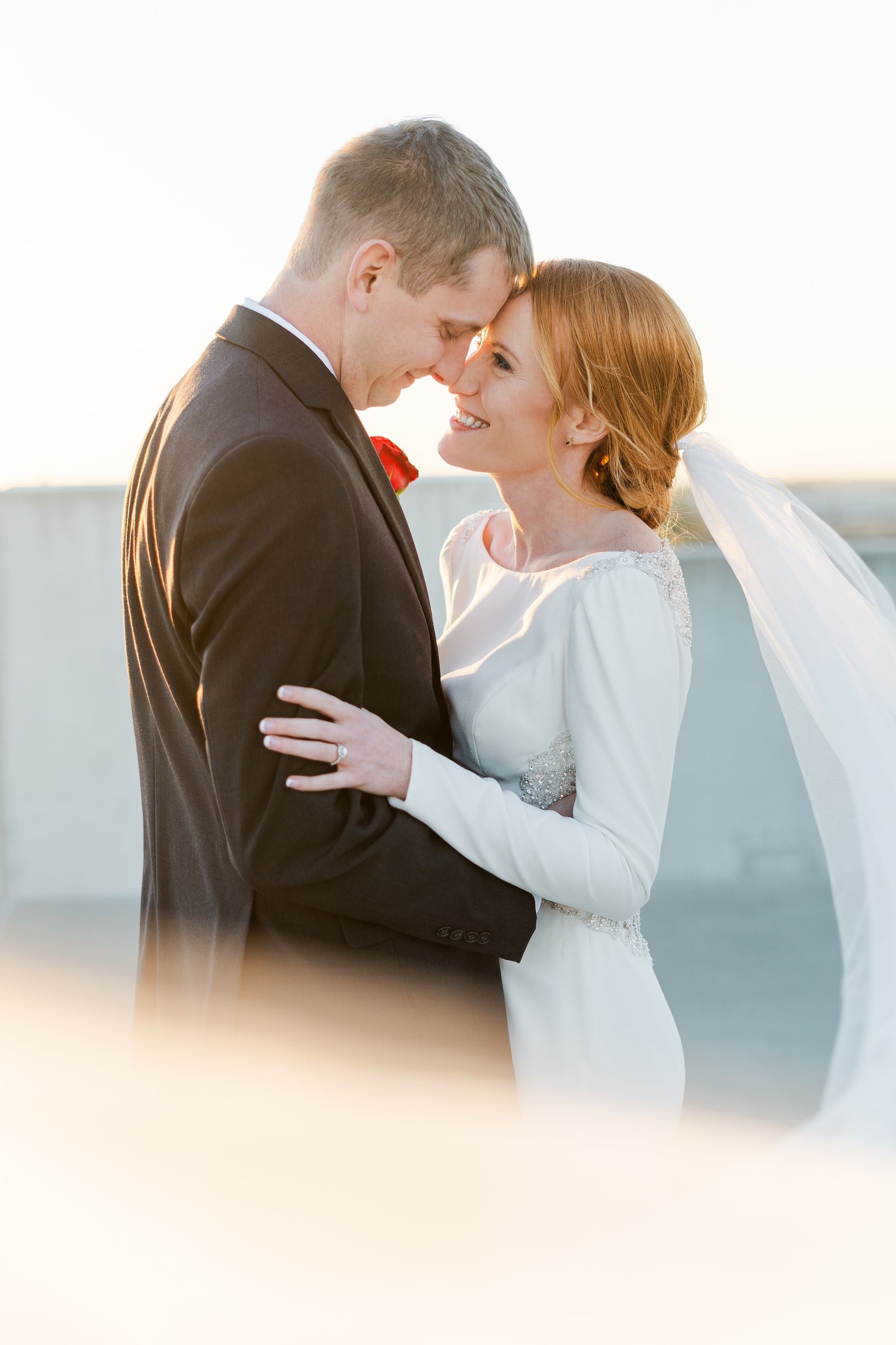 bride and groom smiling with their foreheads together