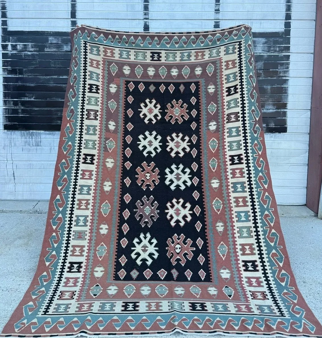 AVAILABLE ~ Vintage Turkish rug with unique coloration
Rectangular in shape with a black center. The black focal point works well with the light blue and terracotta color tones. In overall good vintage condition with minor wear consistent with age a