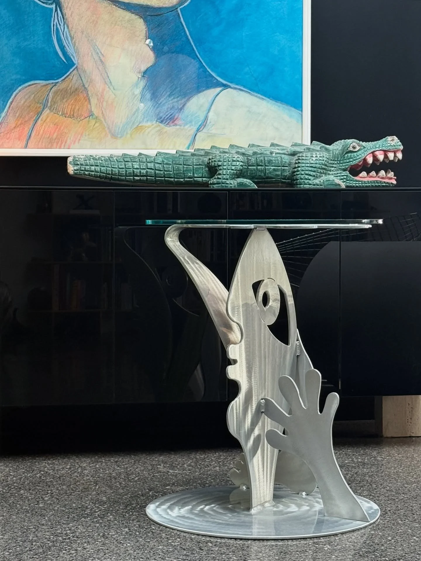 AVAILABLE ~ Postmodern Side Table by Christopher Royal 
Single side table by the Christopher Royal Collection for Rockledge Design Studios, made circa 1980s. The base is made from laser cut aluminum and tabletop is circular glass. The base depicts a