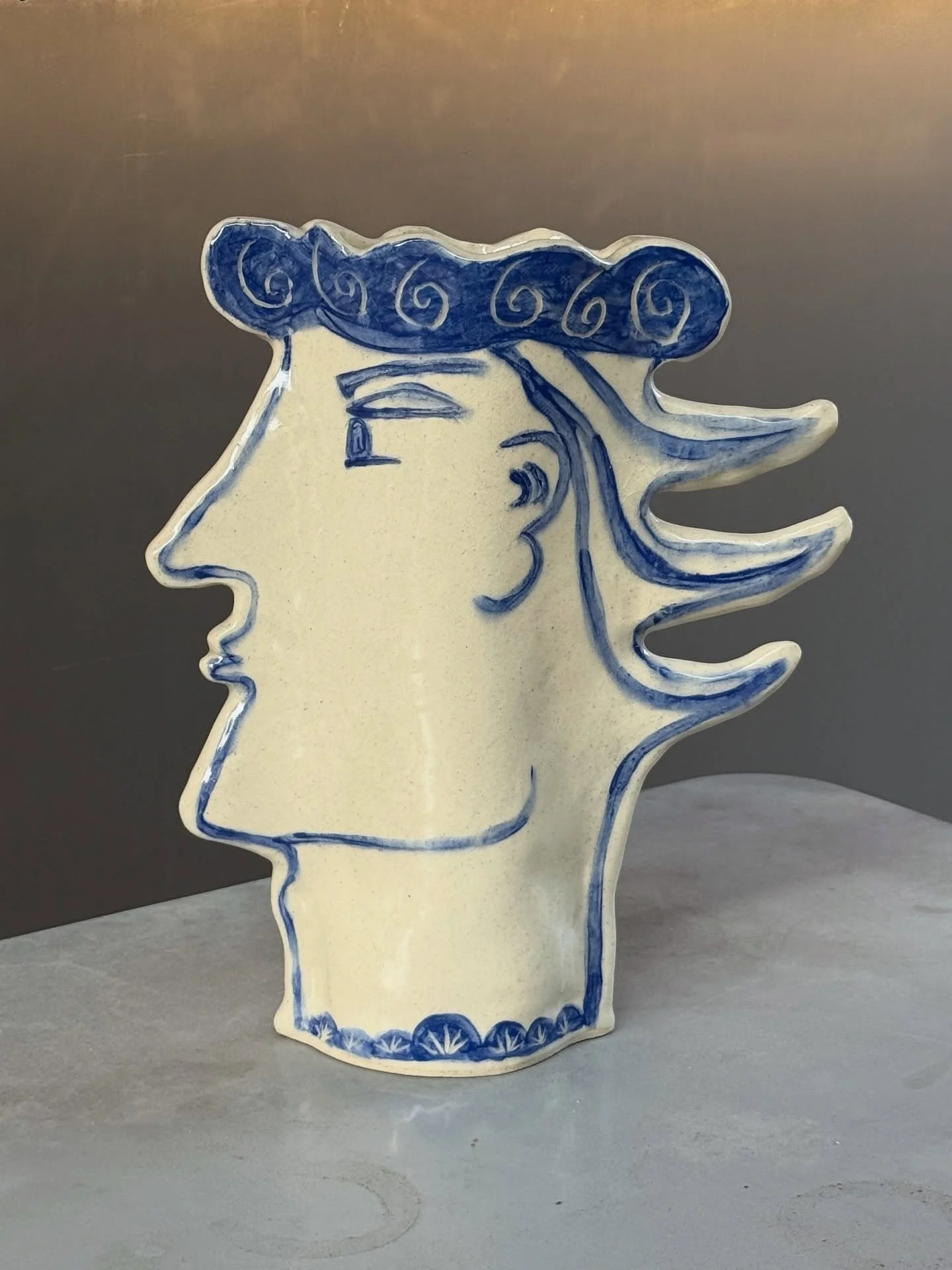 AVAILABLE ~ Large ceramic face vase by local artist @dotsandlinespottery.cary.nc 

A mix of the old world and new age technique. Highly sculpted styled design made from stoneware, underglaze painted on leather hard clay and clear glaze high fired to 