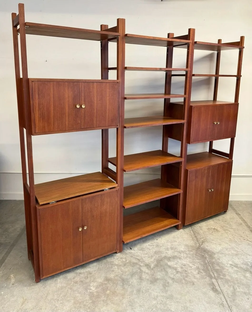 AVAILABLE ~ Vintage freestanding wall unit, made from teak

 This piece features three separate bays that can be bolted together, positioned to your liking, or used as separated single unites. A wonderful piece with a lot of different possibilities. 