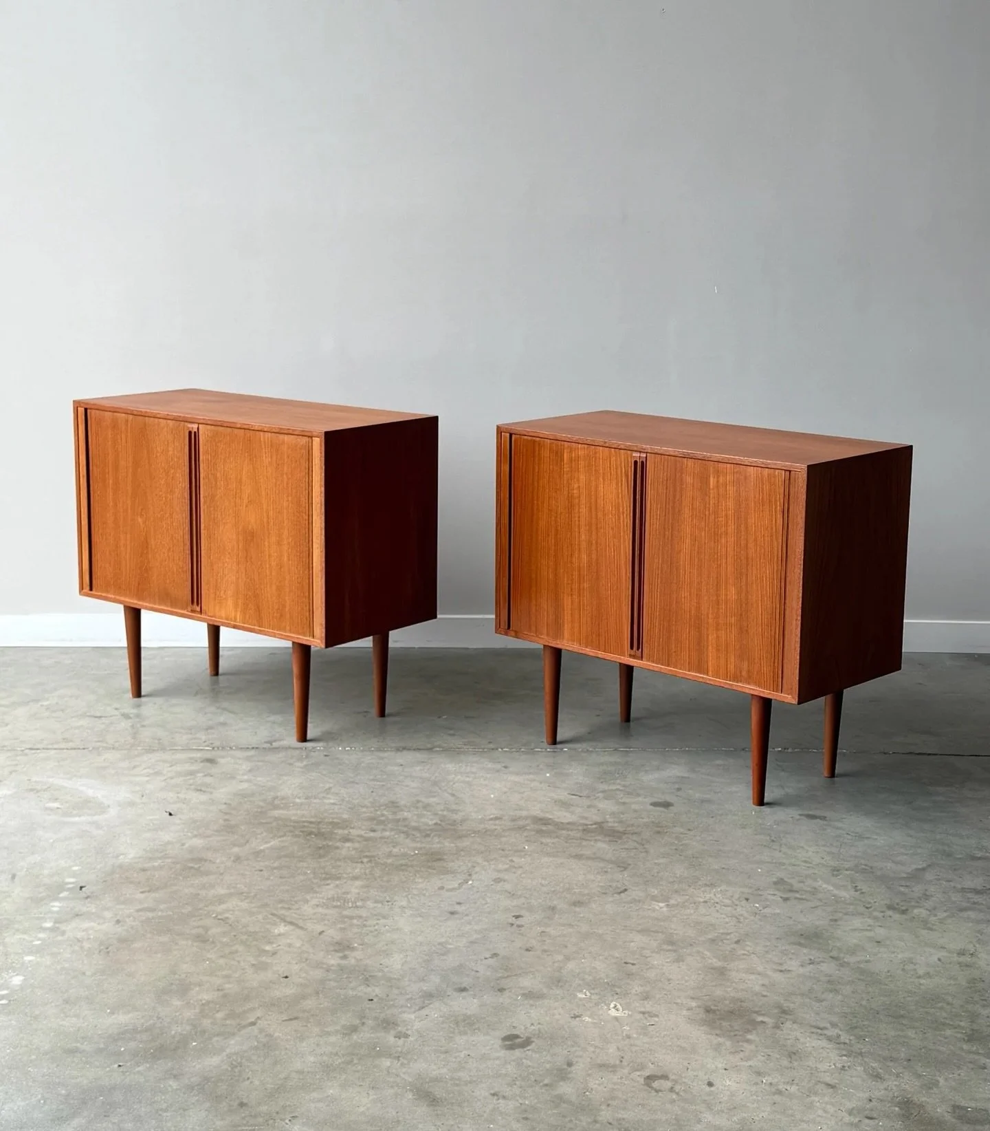 AVAILABLE ~ Mid-century Danish sideboards / record cabinets designed by Kai Kristiansen, circa 1970s. We have two of these cabinets available, priced per cabinet or purchase both and push together to create a long credenza.

Made from teak wood and s