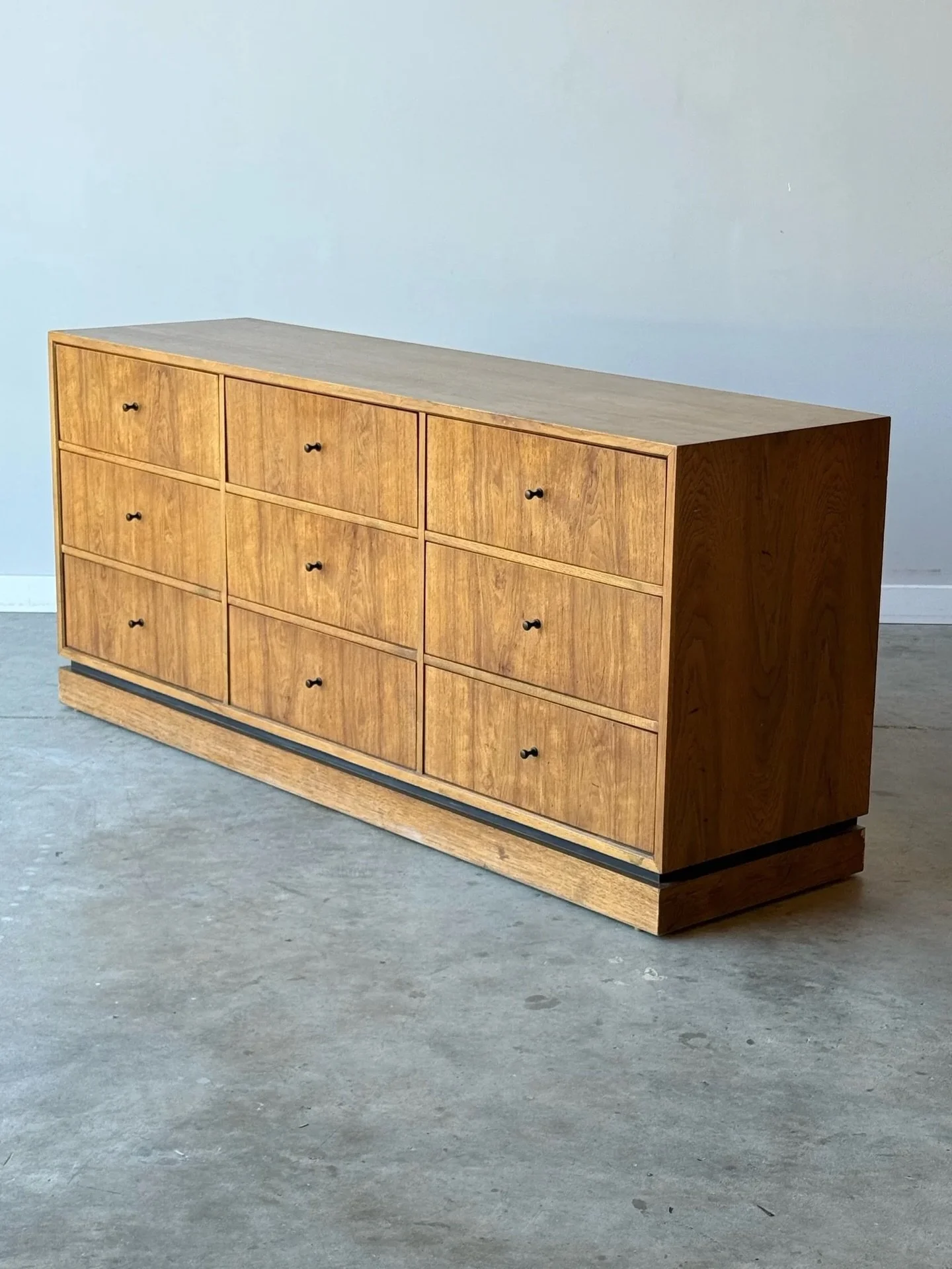 AVAILABLE ~ Mid-century nine drawer dresser manufactured by Drexel. This piece is a part of Drexel&rsquo;s &lsquo;Index&rsquo; line. 

Made from walnut wood and accented with black minimalist drawer pulls. Equipped with a ton of storage potential. Th