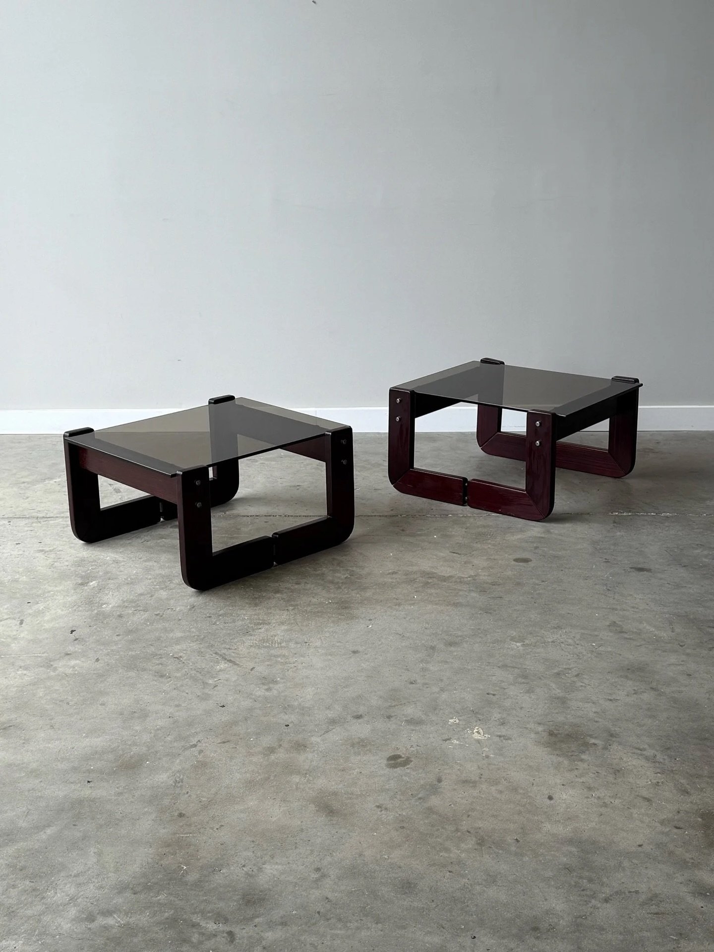 AVAILABLE ~ Mid-century square shaped side tables designed by Percival Lafer, circa 1970s. 

The base of the tables are made from sculpted Brazilian rosewood. Rosewood known for being especially rich in saturation and grain. The two L-shaped legs con