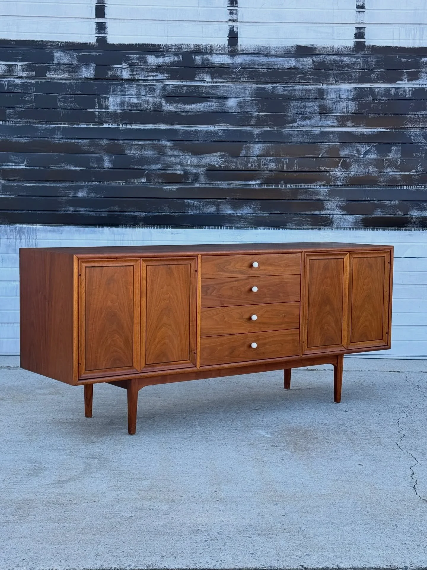 SOLD ~ Mid-century credenza by Kipp Stewart and Stewart MacDougall for Drexel. This piece is a part of Drexel&rsquo;s &lsquo;Declaration&rsquo; line. Danish inspired and American made. 

The left and right-hand sections feature push doors that open t