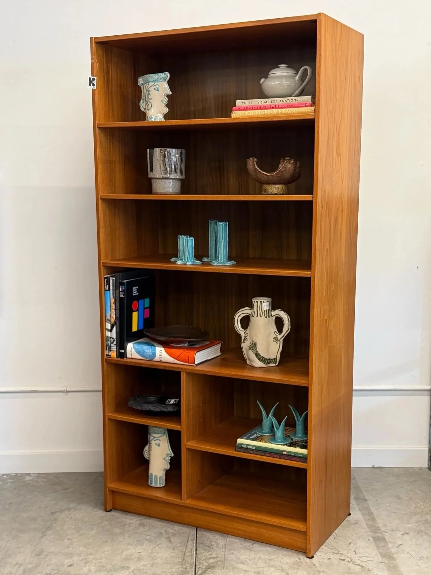 AVAILABLE ~ Mid-century bookshelf made from teak wood, Denmark. This tall bookshelf features great woodgrain and perfect for storing books, displaying pottery, or showcasing whatever your collection may be.

There are six shelves of varying sizes, al