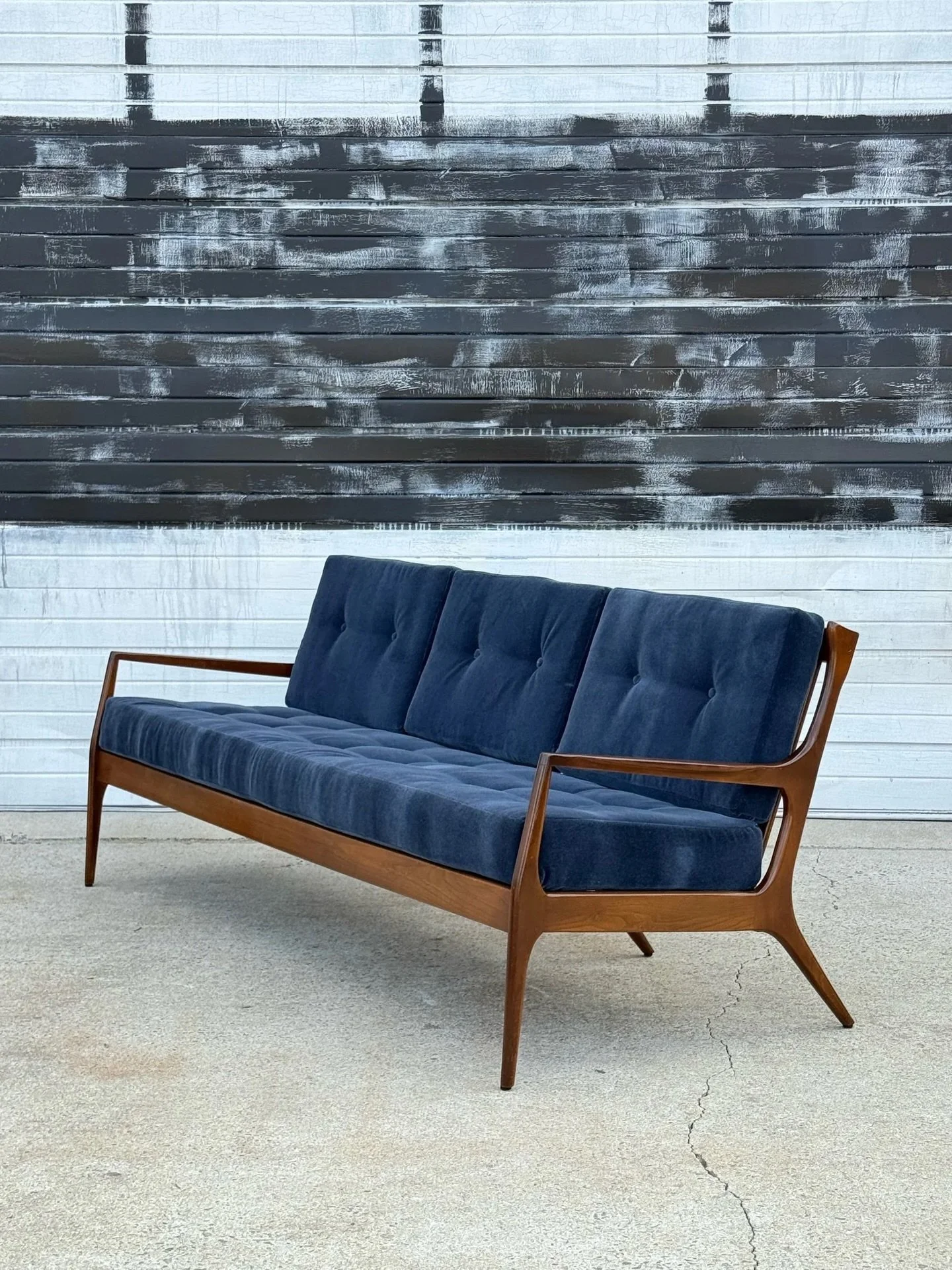 AVAILABLE ~ Mid-century walnut frame three-seater sofa. Newly reupholstered with new foam and new fabric. The fabric is a rich deep blue mohair. A moody pop of color that compliments the warm wood tone quite well. The cushions are tufted with buttons