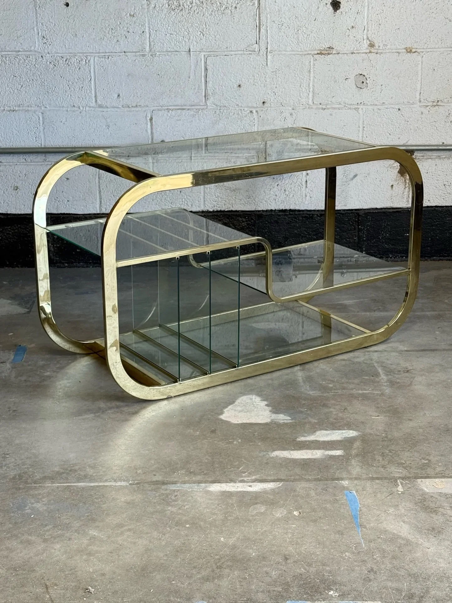 AVAILABLE ~ Vintage brass bar server / record holder. In the style of Milo Baughman and manufactured by Design Institute of America (DIA).

Original brass frame with glass inserts. The glass divides the piece into multiple sections for various sized 