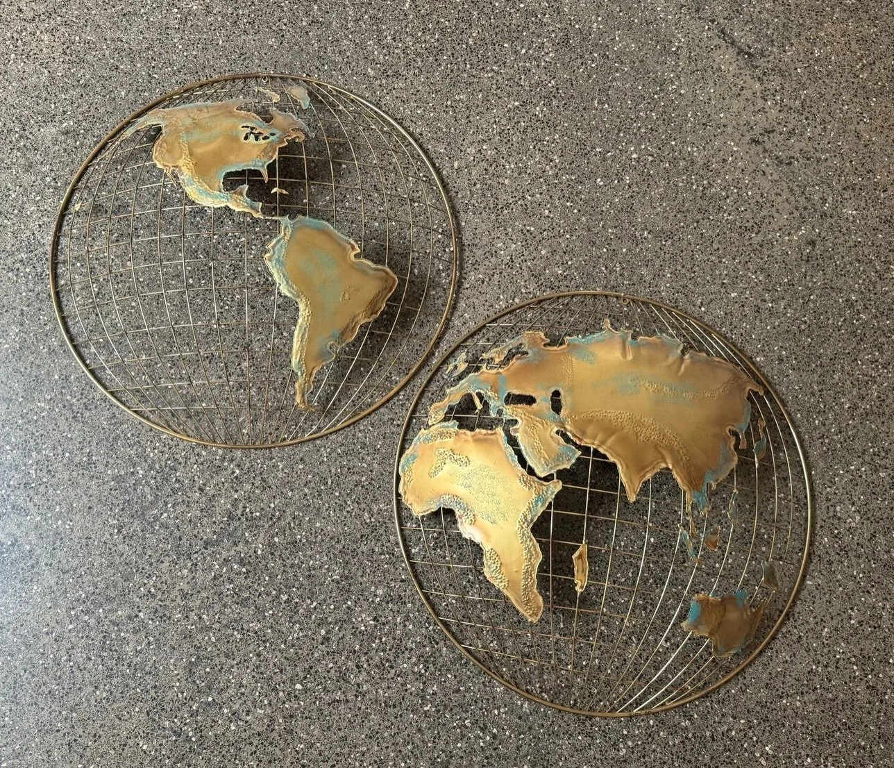 AVAILABLE ~ Mid-century brass wall sculpture art. By Curtis Jere, signed 1982, and sold as a pair. 

Depicting a map / globe. A great pair for an office with perfect patina. In overall good vintage condition with minor wear consistent with age and us