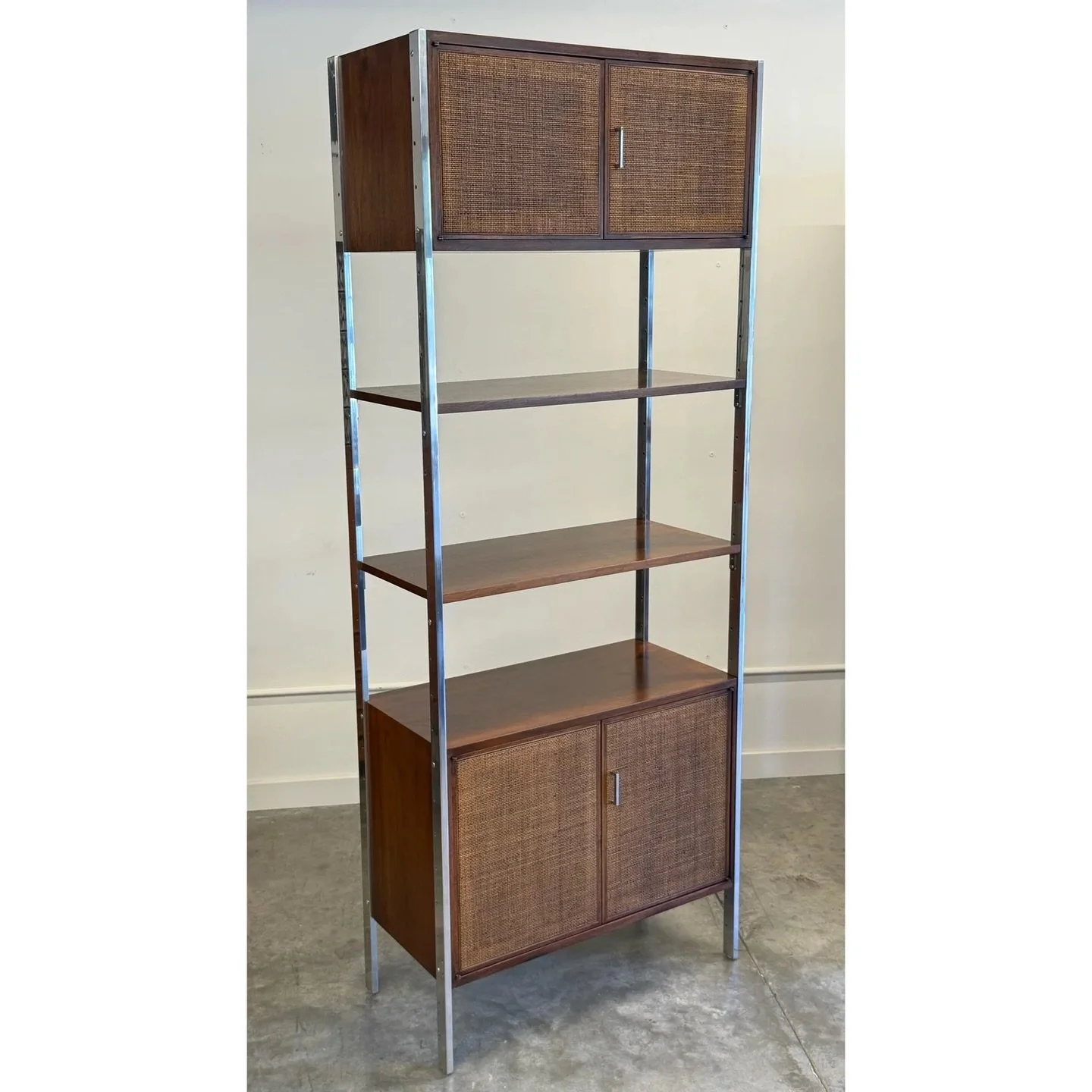 SOLD ~ Mid-century single bay wall unit designed by Jack Cartwright for Founders, circa 1960s. 

This unit is made from walnut wood with cane accents and chrome supports. An incredible mix of materials that wonderfully showcases American mid-century 