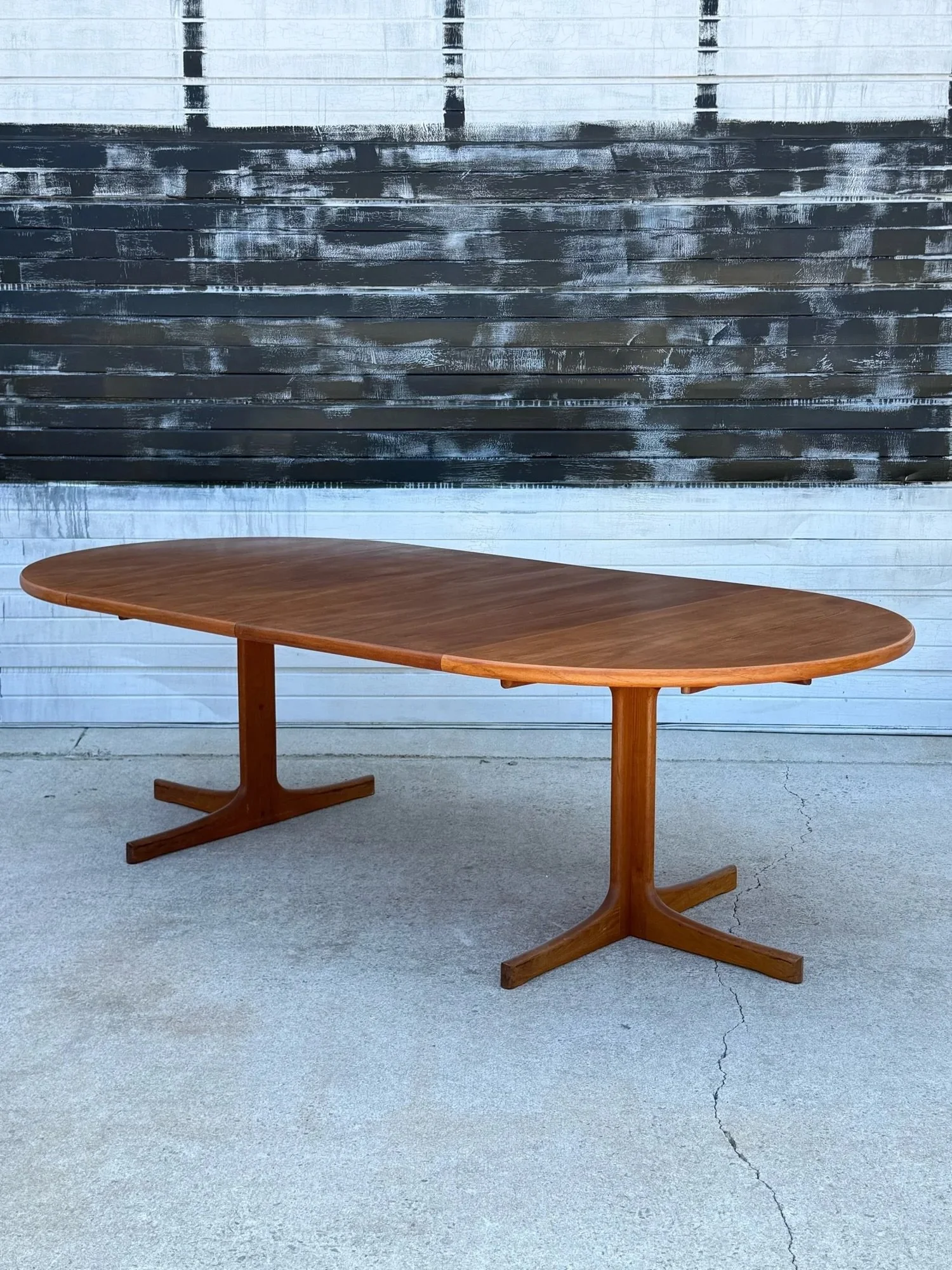 SOLD ~ Mid-century oval expanding dining table. Made in Denmark by Karl-Erik Ekselius and crafted from teak wood. This dining table features two large removable leaves. If completely removed, the table becomes circular.

Sitting atop pedestal style t