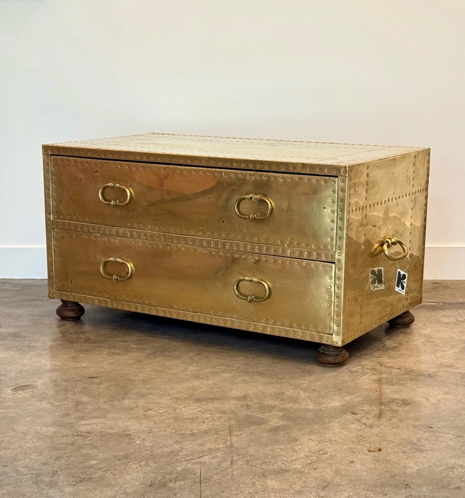 AVAILABLE ~ Vintage brass chest of drawers manufactured by Sarreid Ltd., Spain. 

This piece is rectangular in shape and features two spacious drawers. Each drawer features two original brass handles. There are also large brass handles on each side o